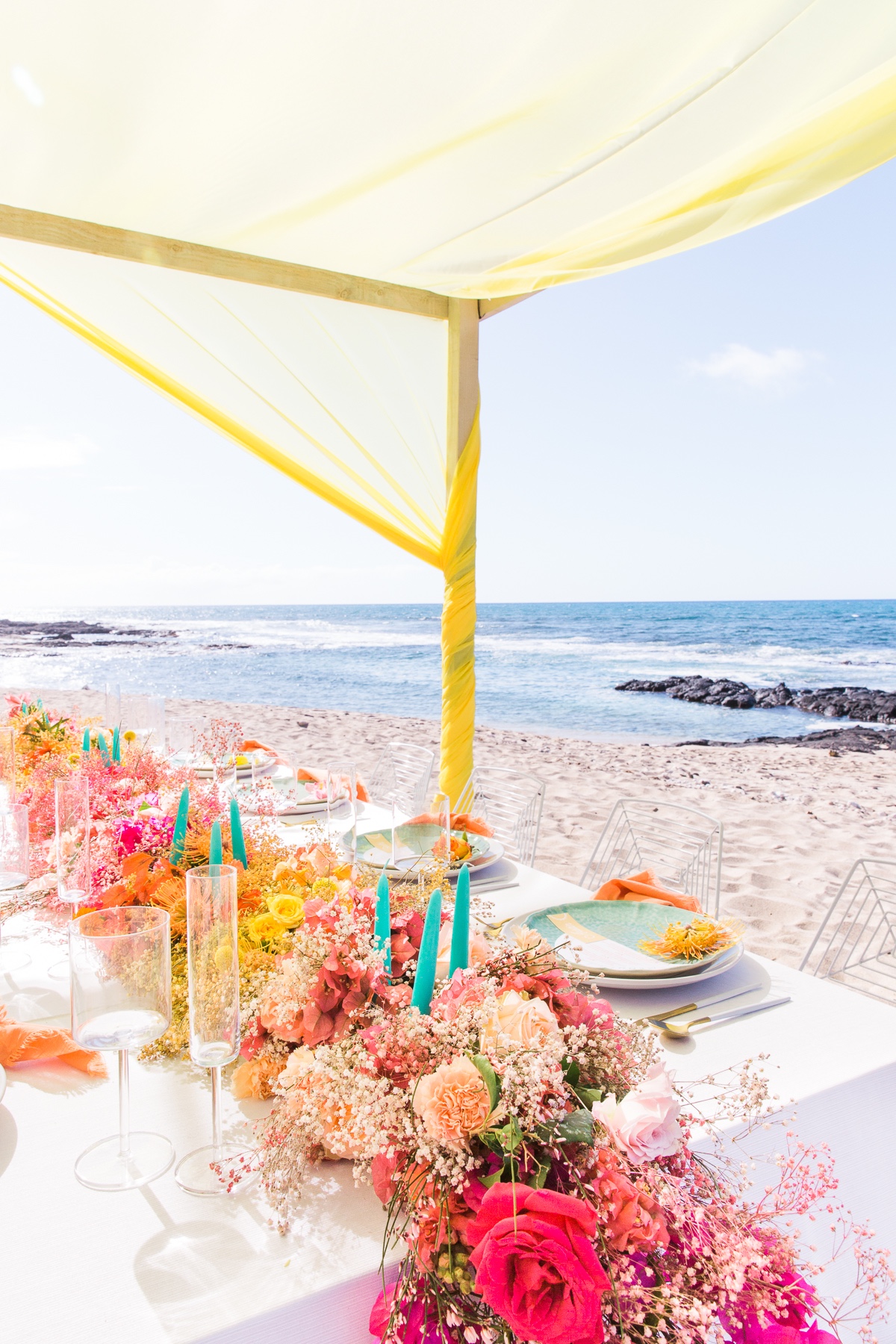 rainbow floral table runner at beachside wedding reception