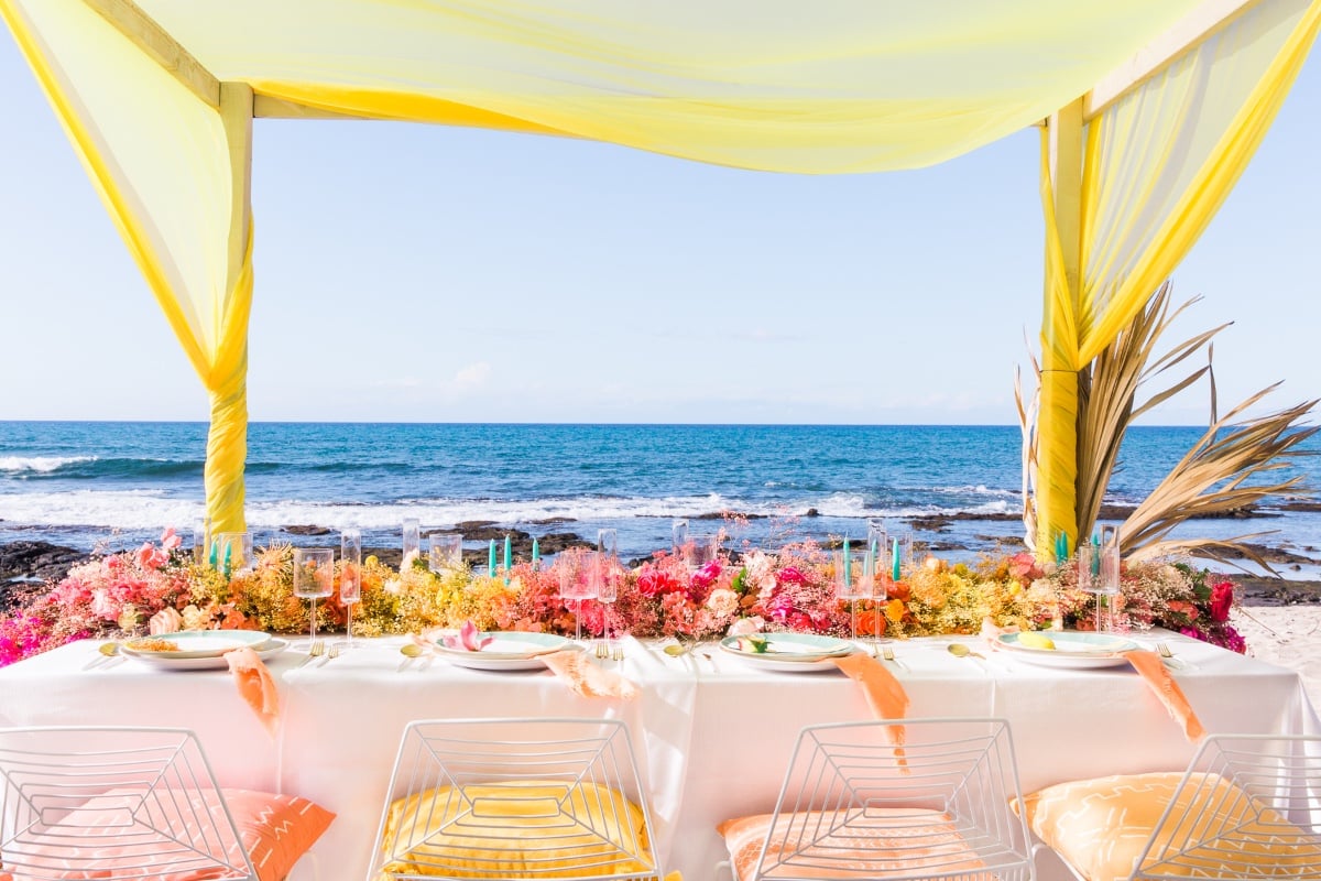 rainbow floral table runner at beachside wedding reception