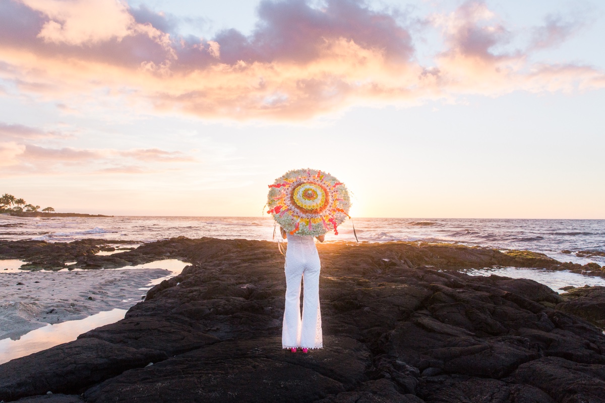 bride standing on lava at sunset in Hawaii