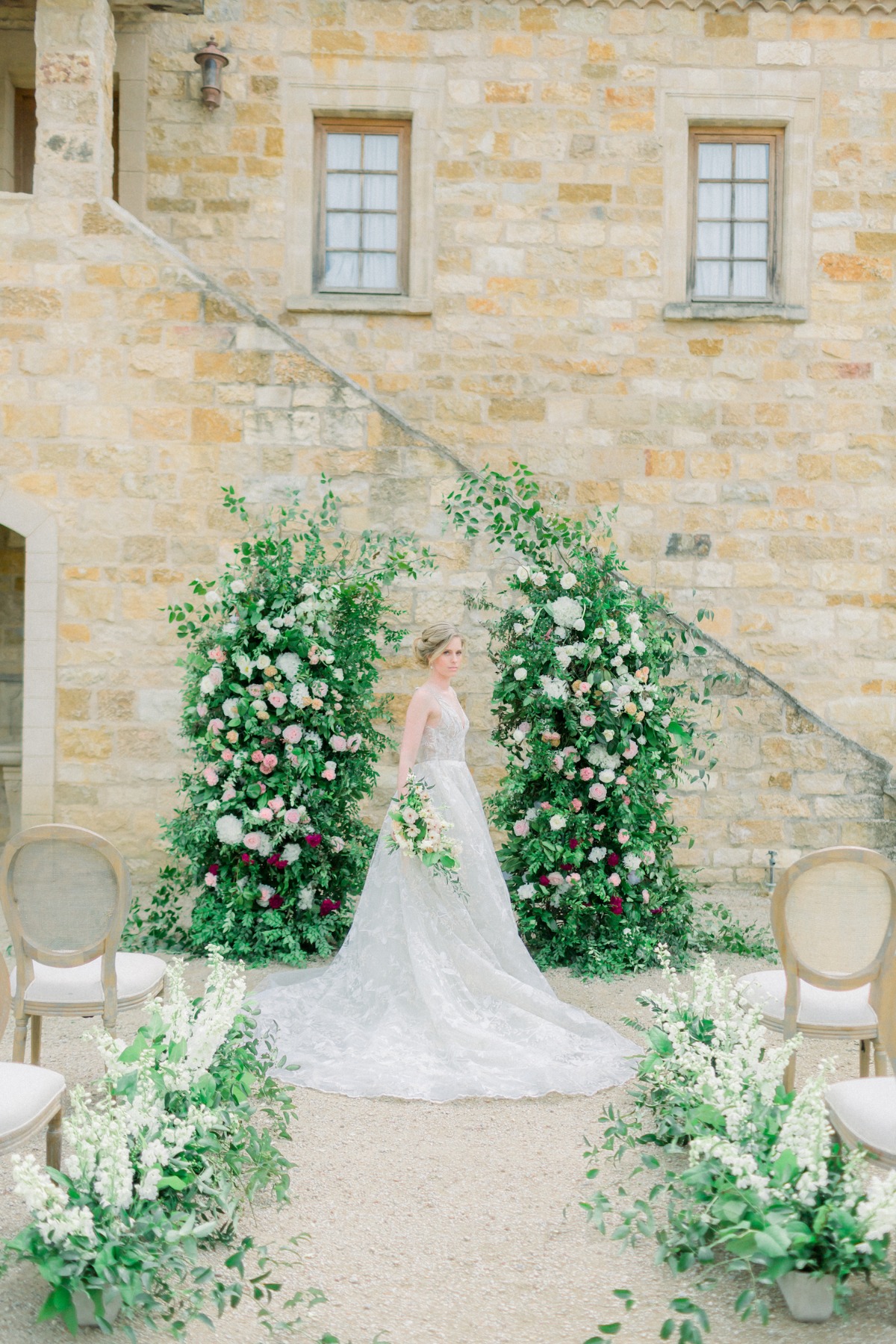 Outdoor rustic wedding ceremony with floral arch