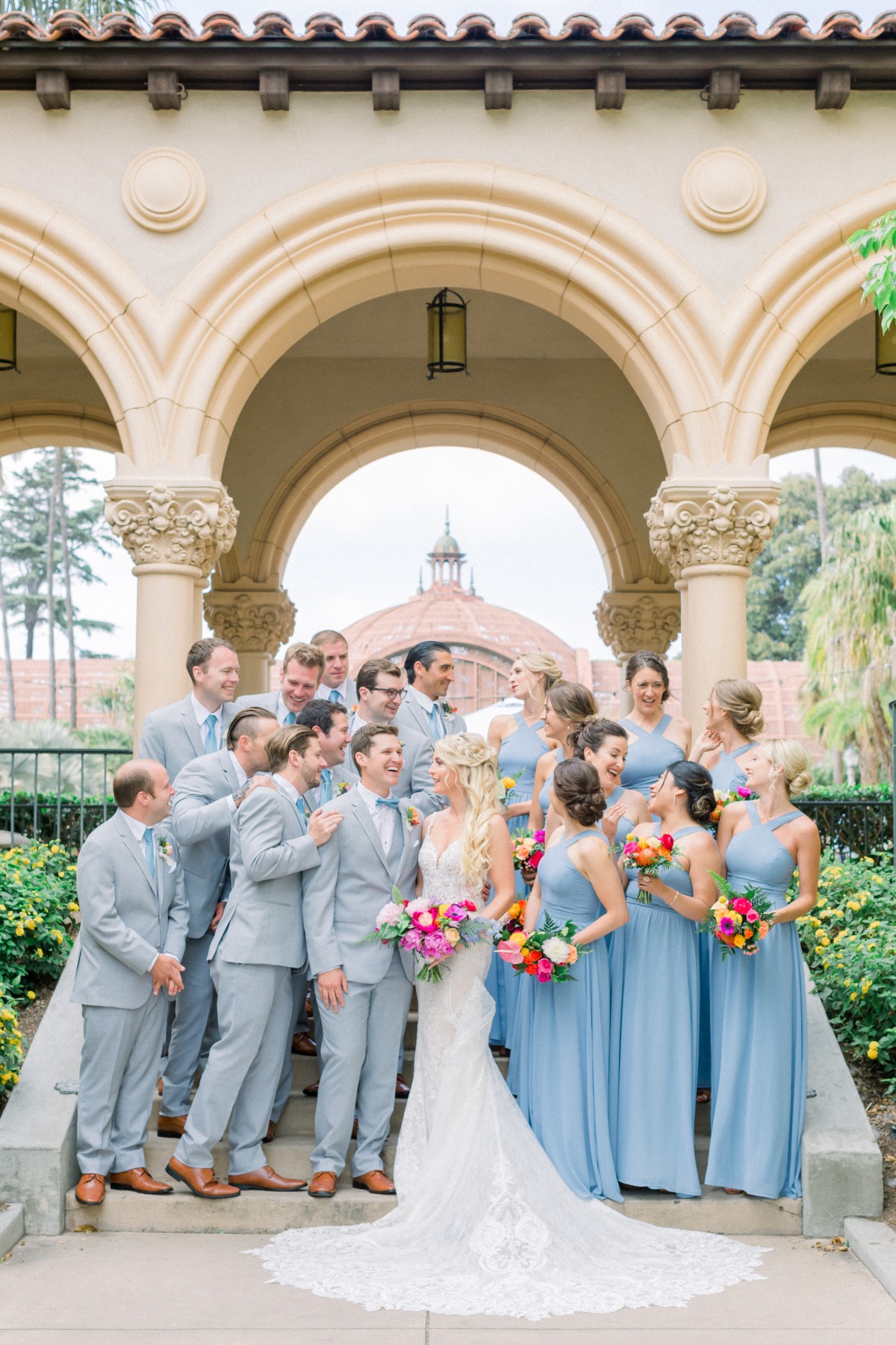 gray and blue wedding party with bright wedding bouquets