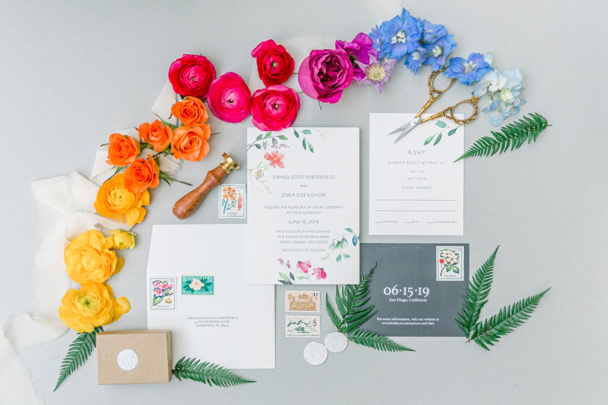 styled flat lay with rainbow wedding invitations