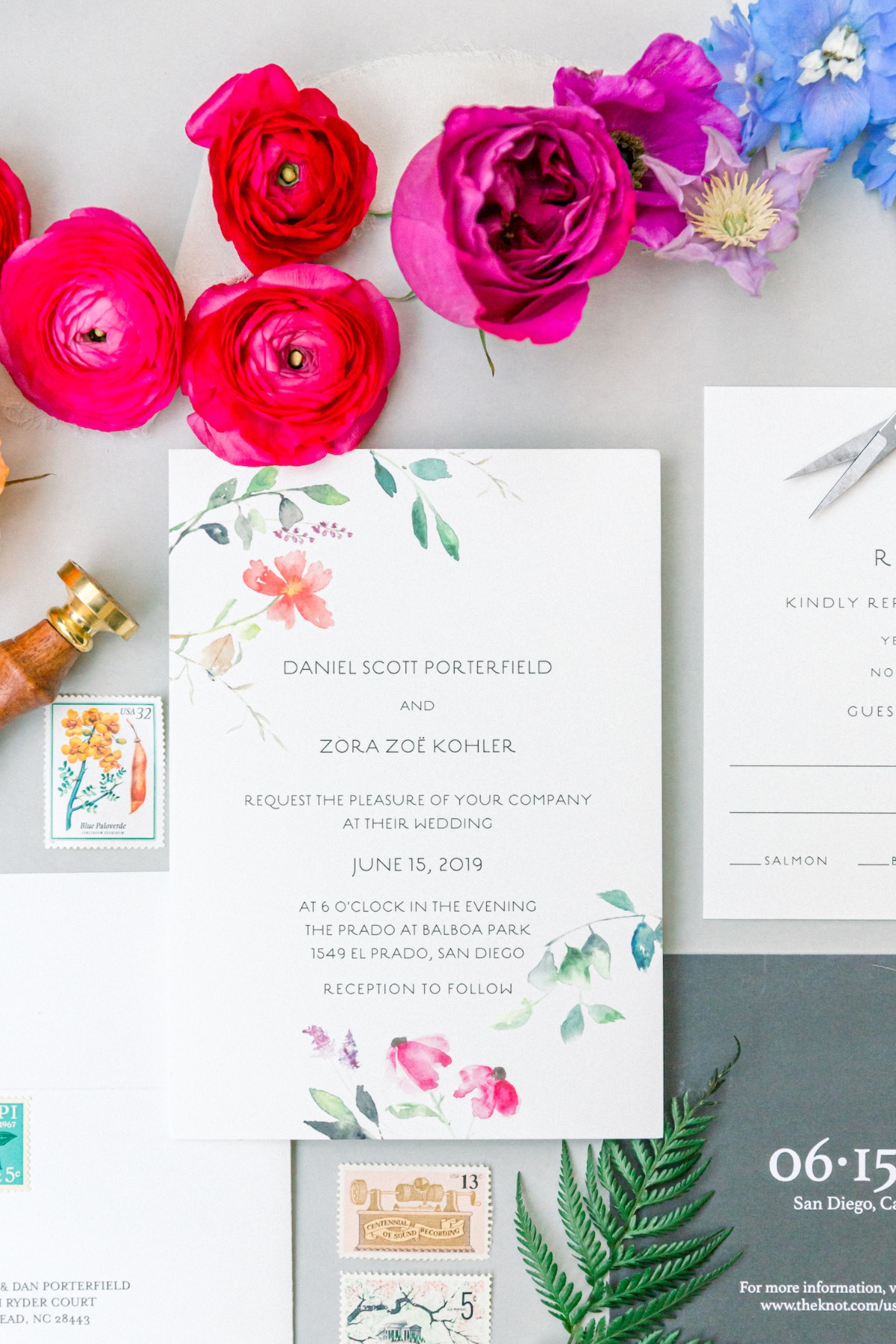 styled flat lay with rainbow wedding invitations