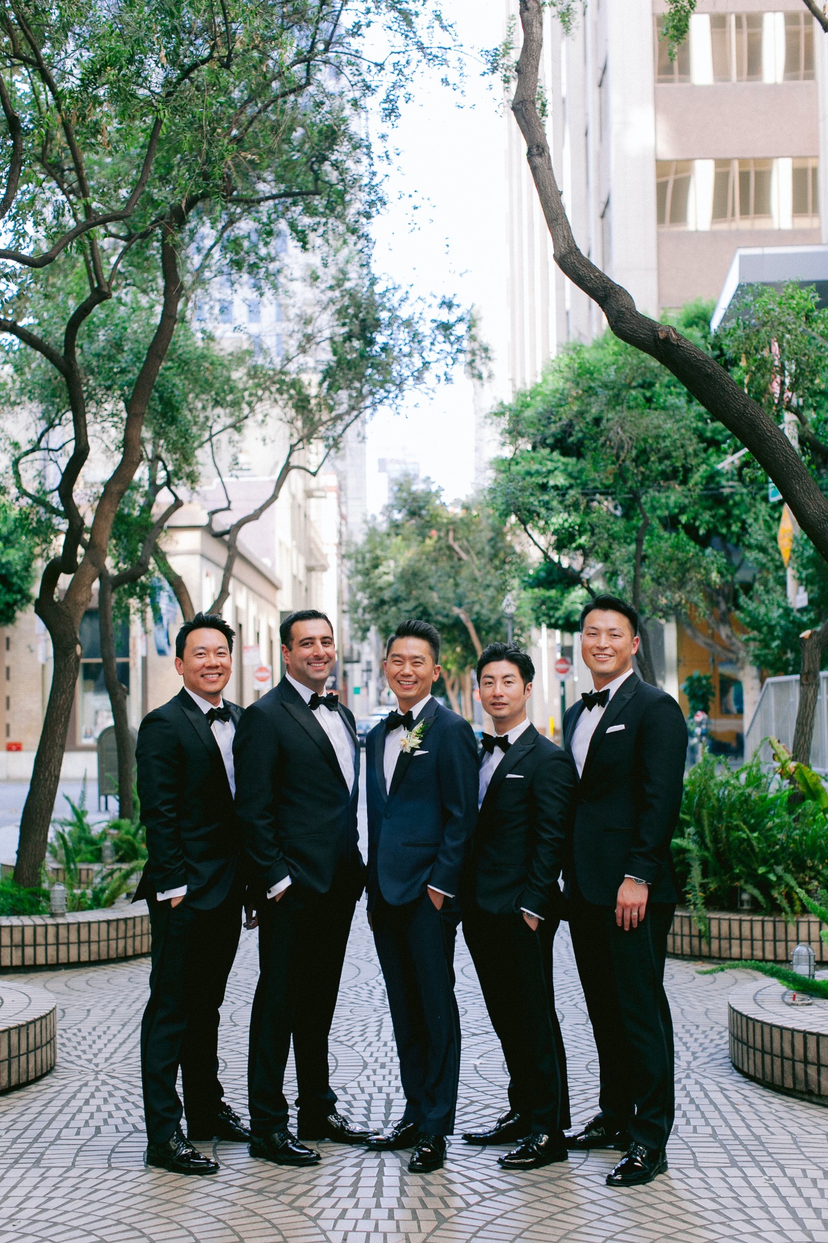 groomsmen in black tuxedos