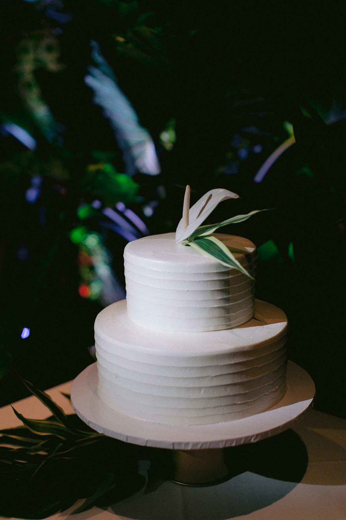 white wedding cake with single white tropical flower