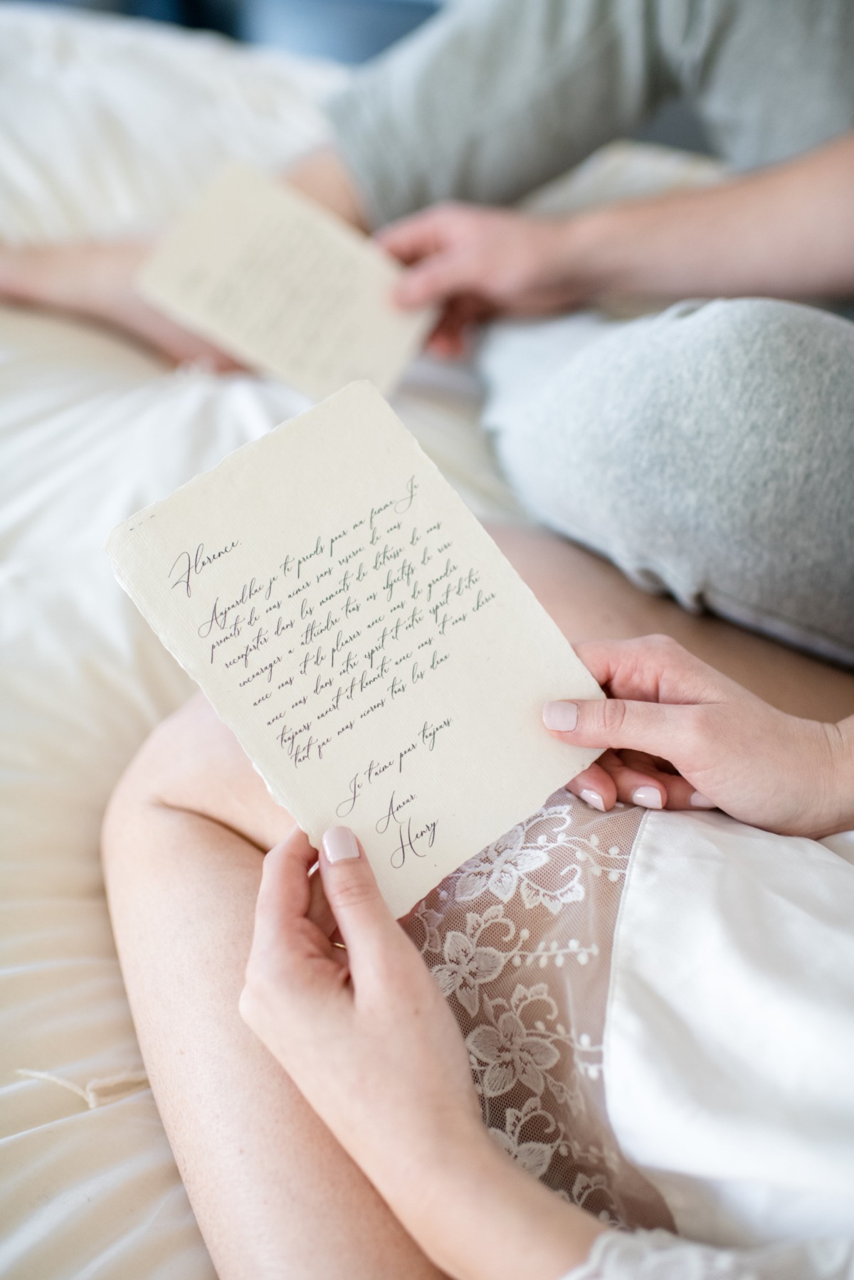 Couple reading love letters on bed, romantic moment