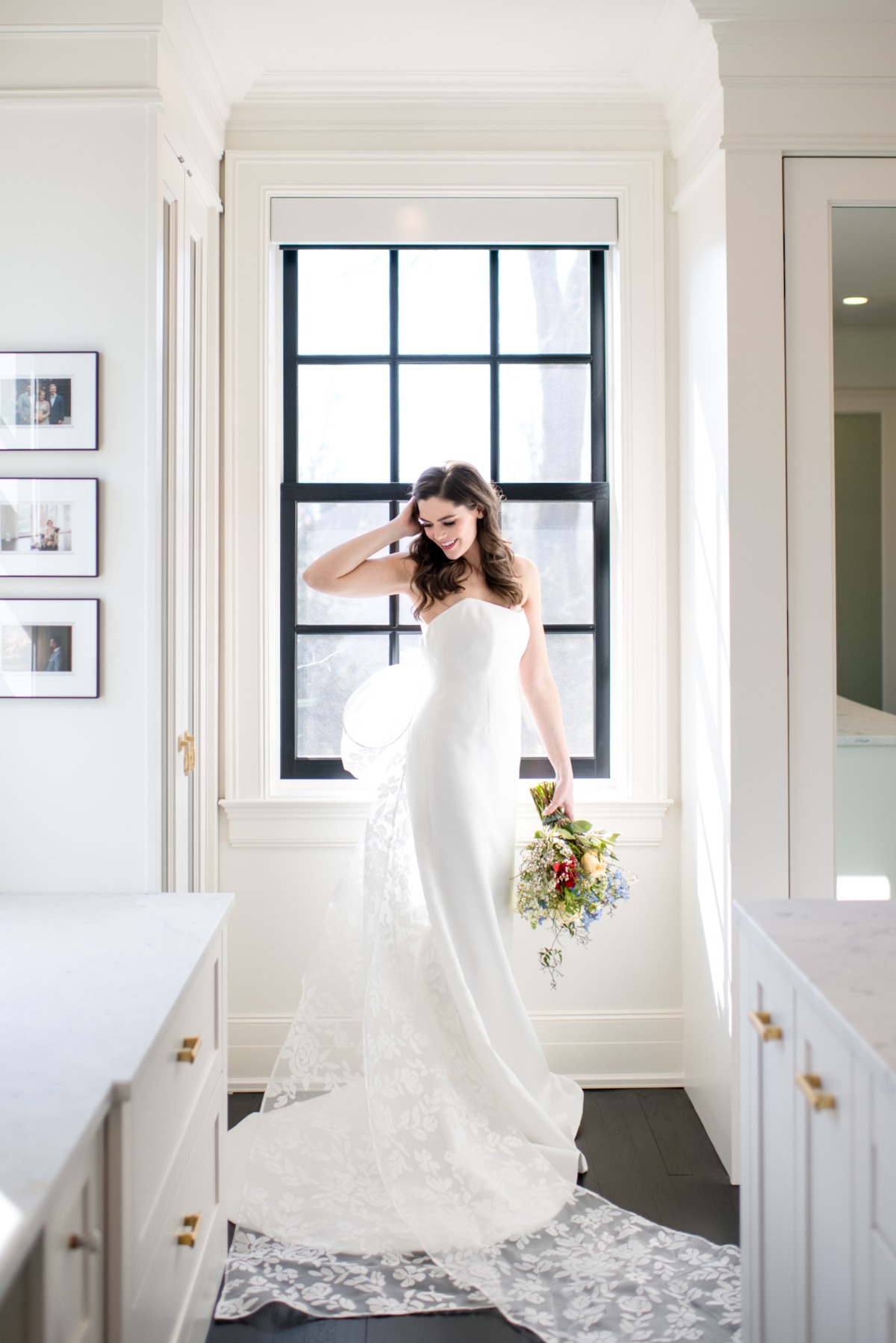 Elegant bride in a white dress with a bouquet, smiling in the sunlight