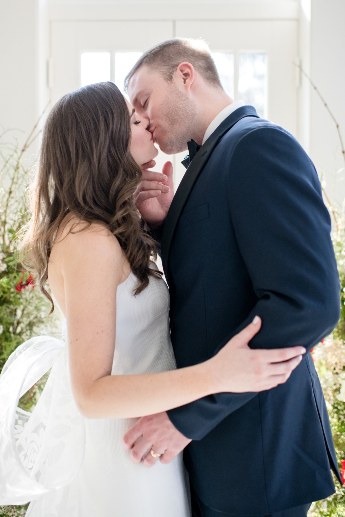 Bride and groom kissing during their wedding ceremony