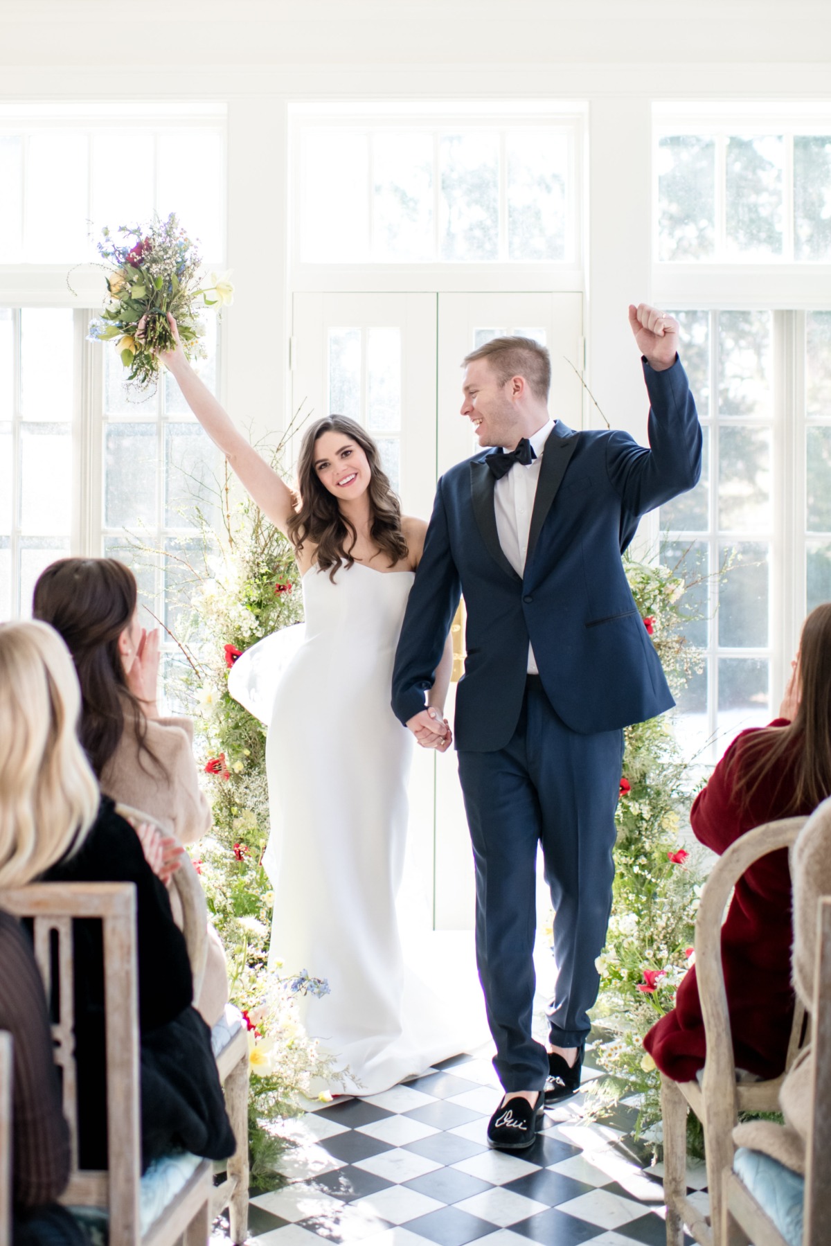 Newlyweds celebrate their marriage as they walk down the aisle