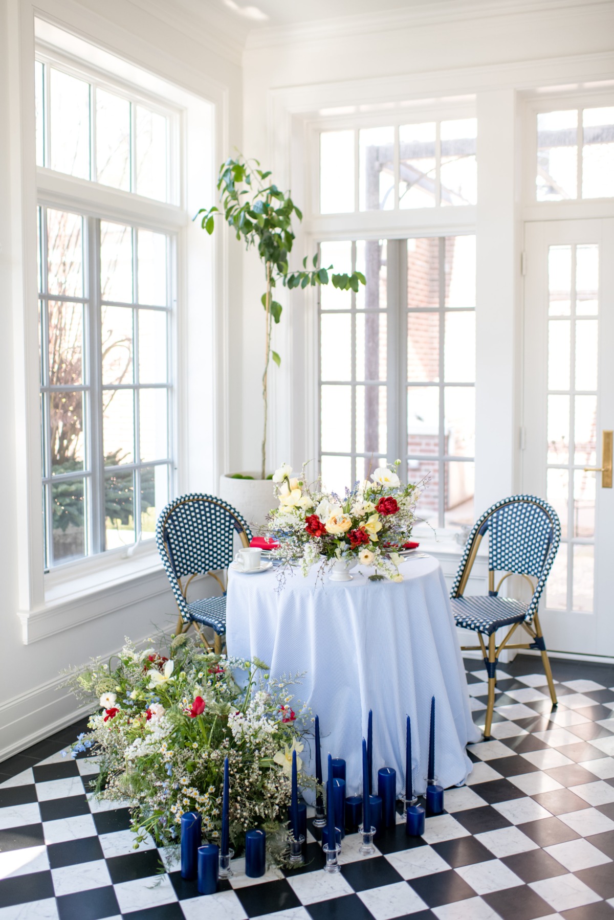 Elegant table setting with flowers and candles in sunroom