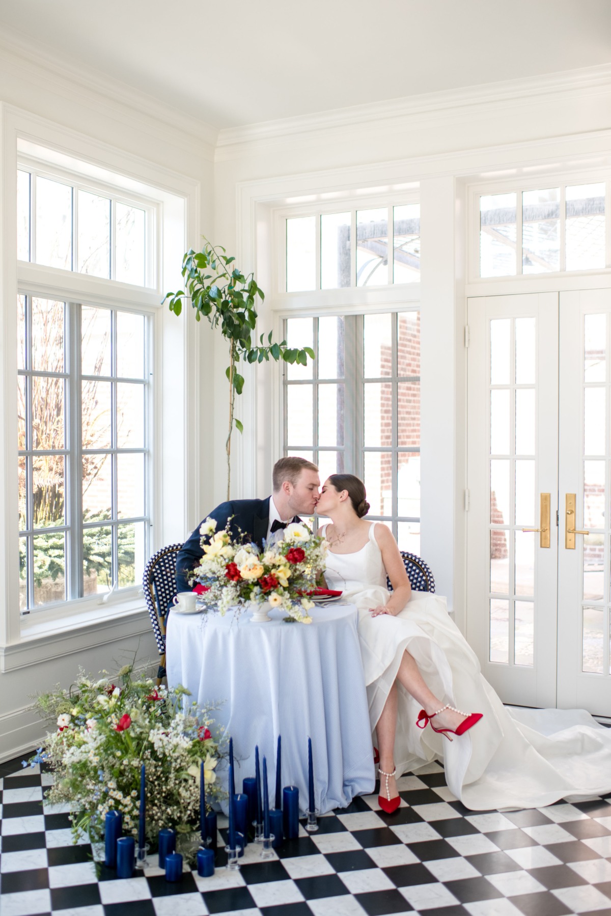 Newlyweds share a kiss at a beautifully decorated wedding table