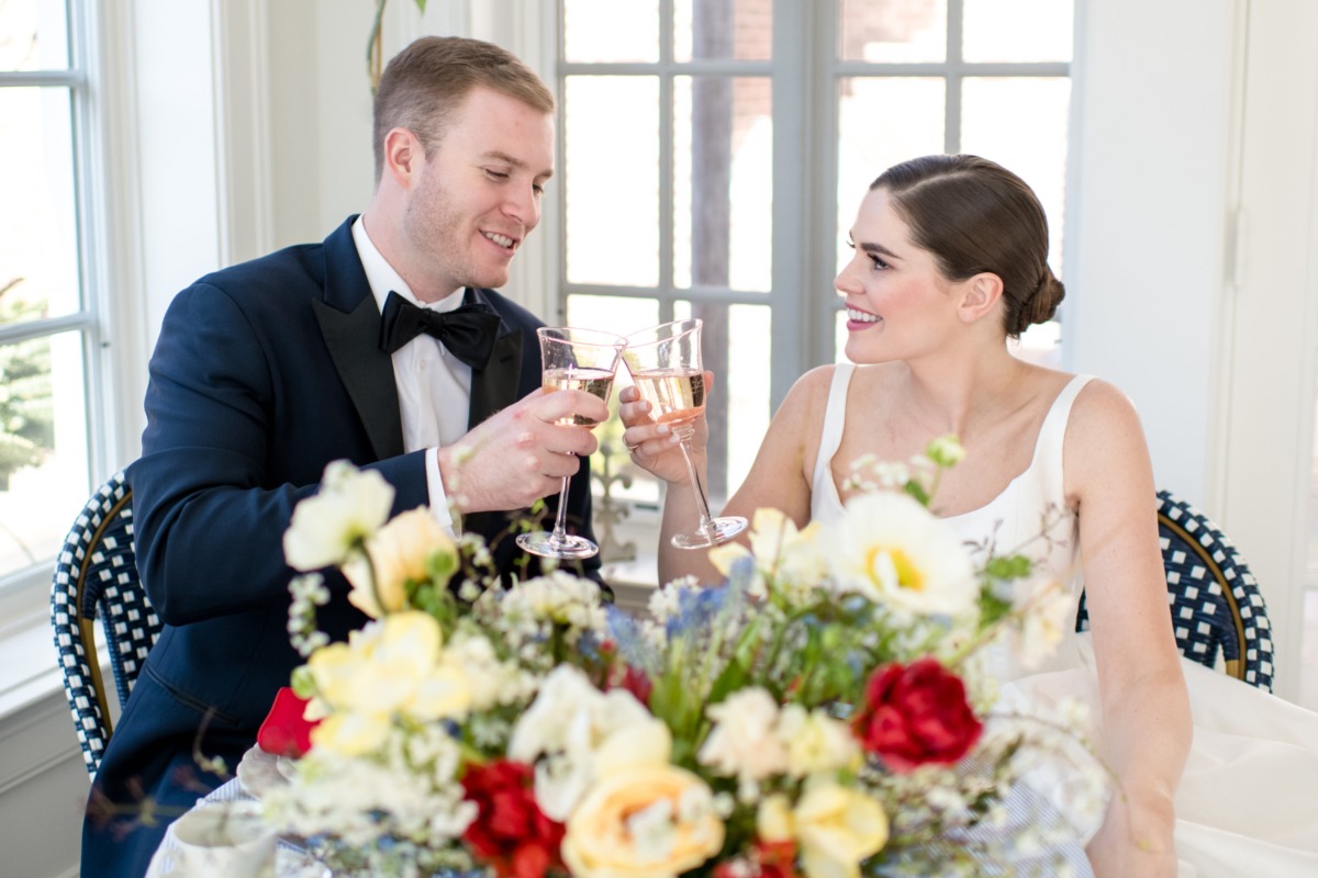Newlyweds toast with champagne in a bright wedding setting