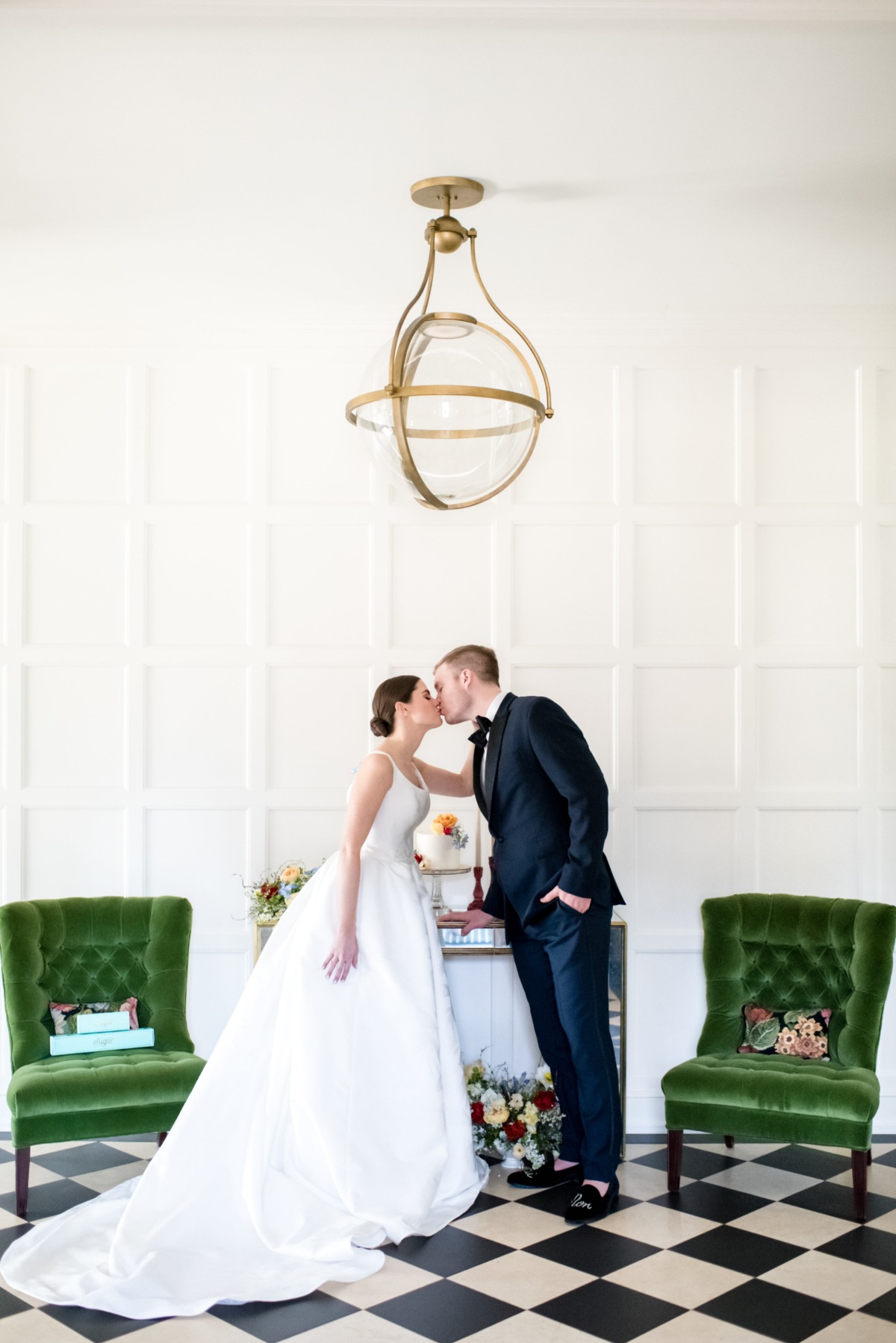 Newlyweds sharing a kiss at a wedding with stylish decor