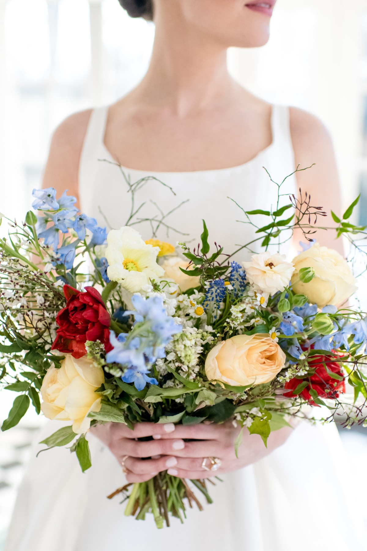 Bride holding a colorful bouquet of flowers at her wedding