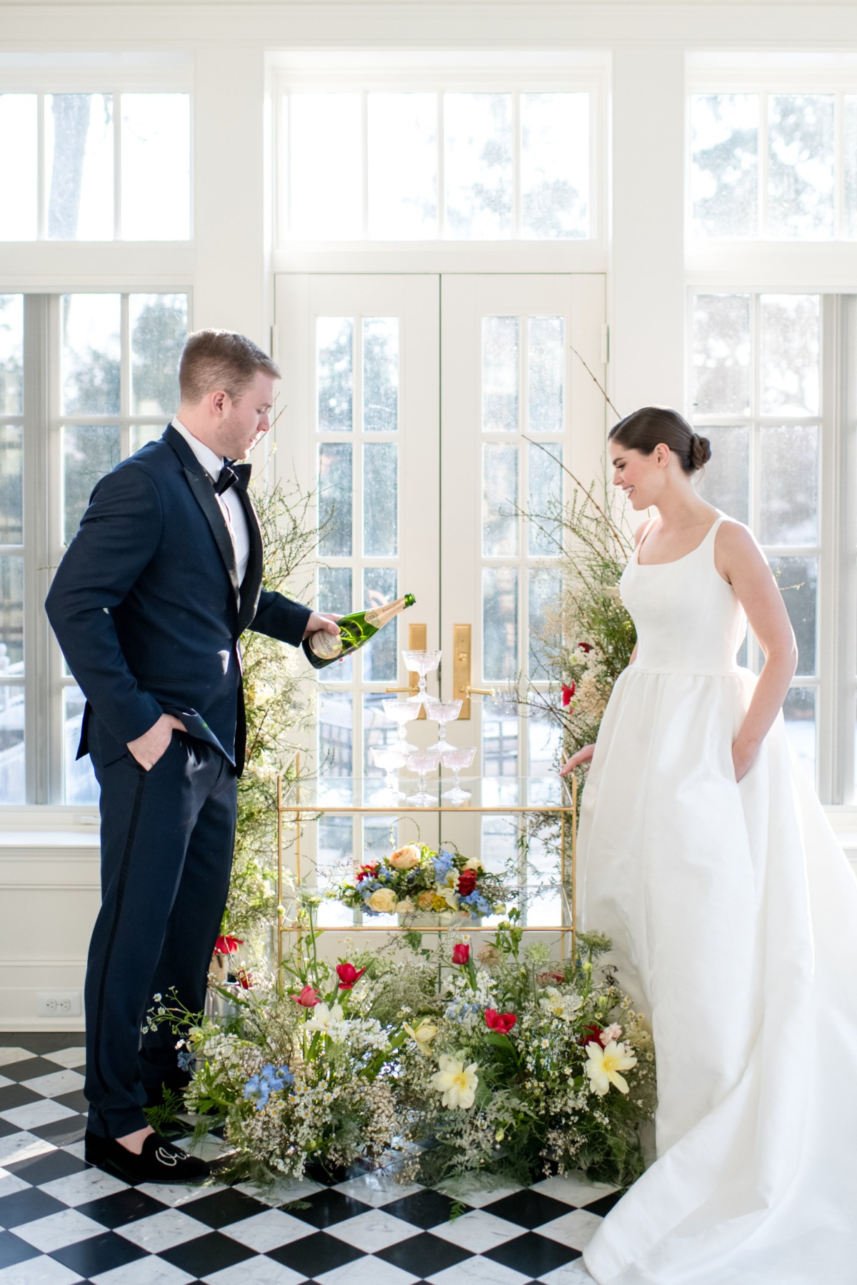 Bride and groom pouring champagne at their wedding
