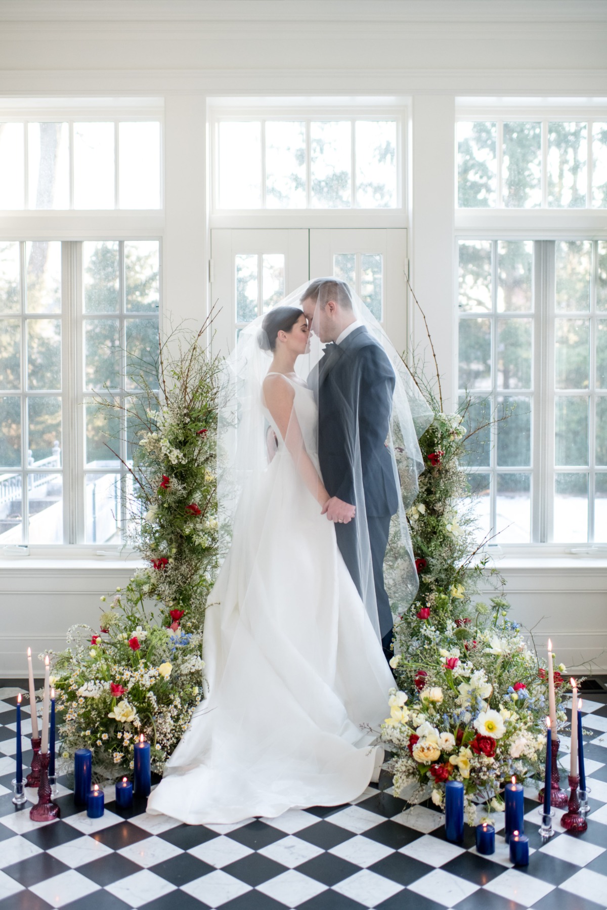 Elegant couple pose idea surrounded by florals and candles