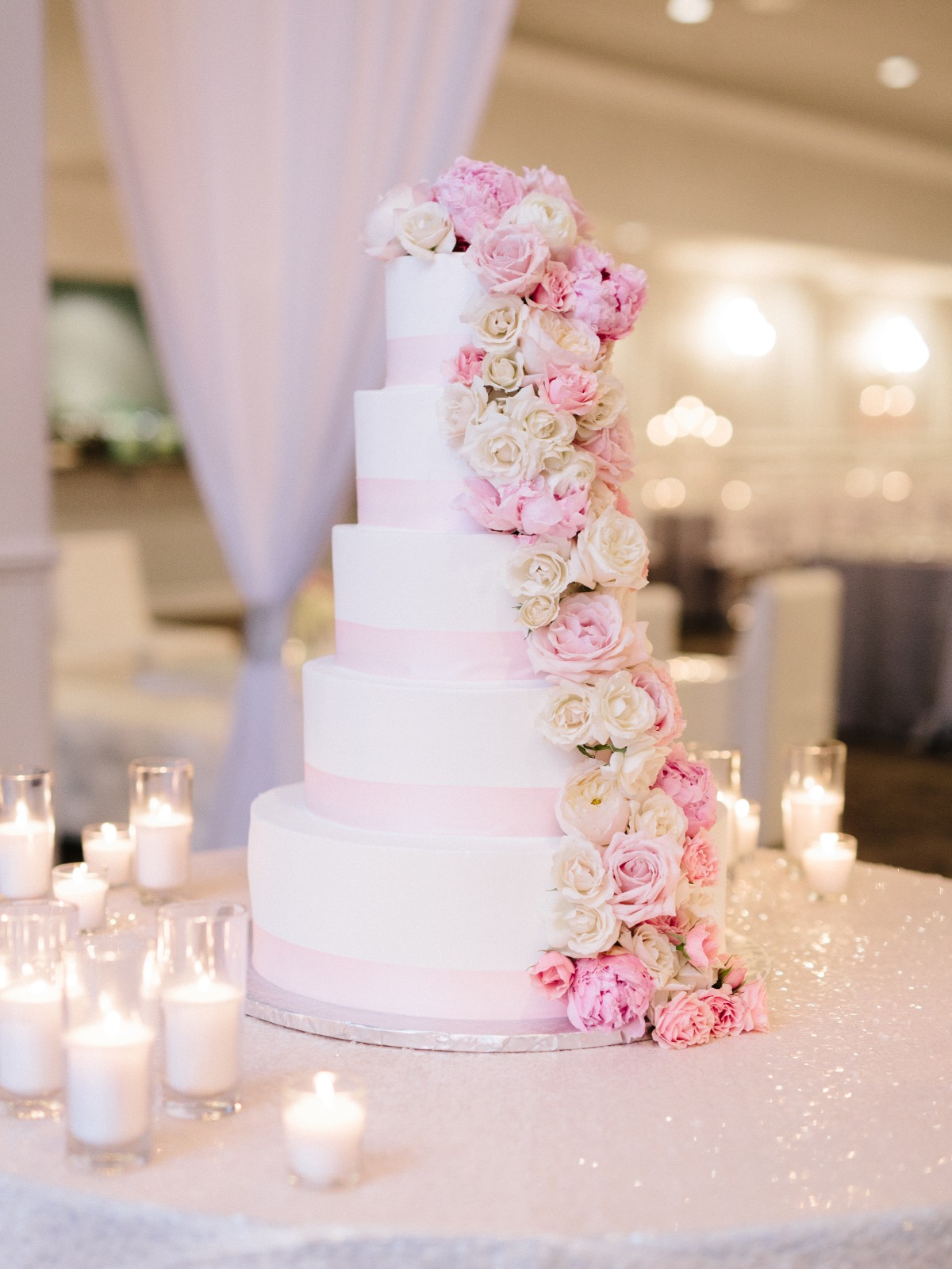 five layer wedding cake with cascading florals