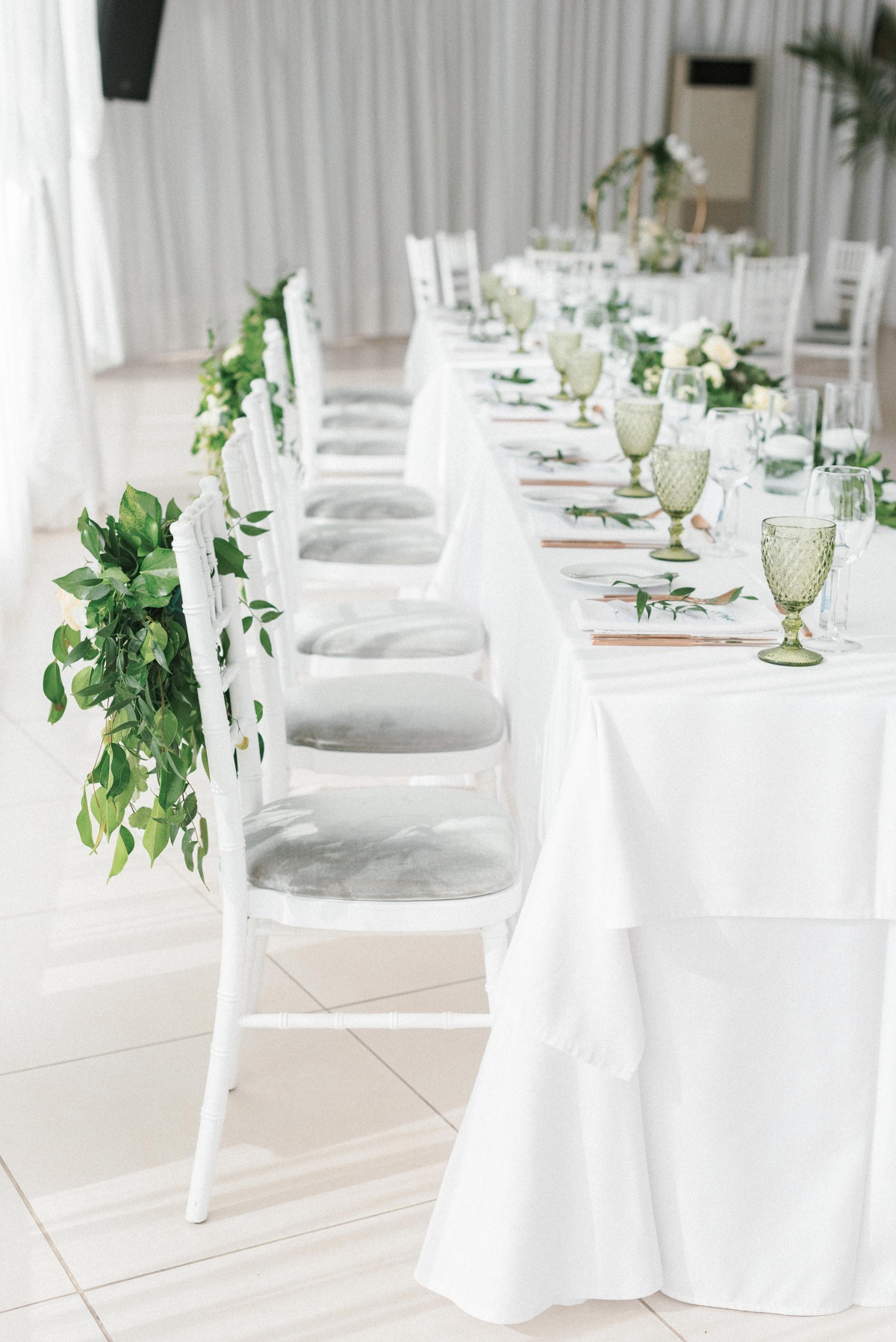all white wedding reception with circle ivy wedding centerpiece