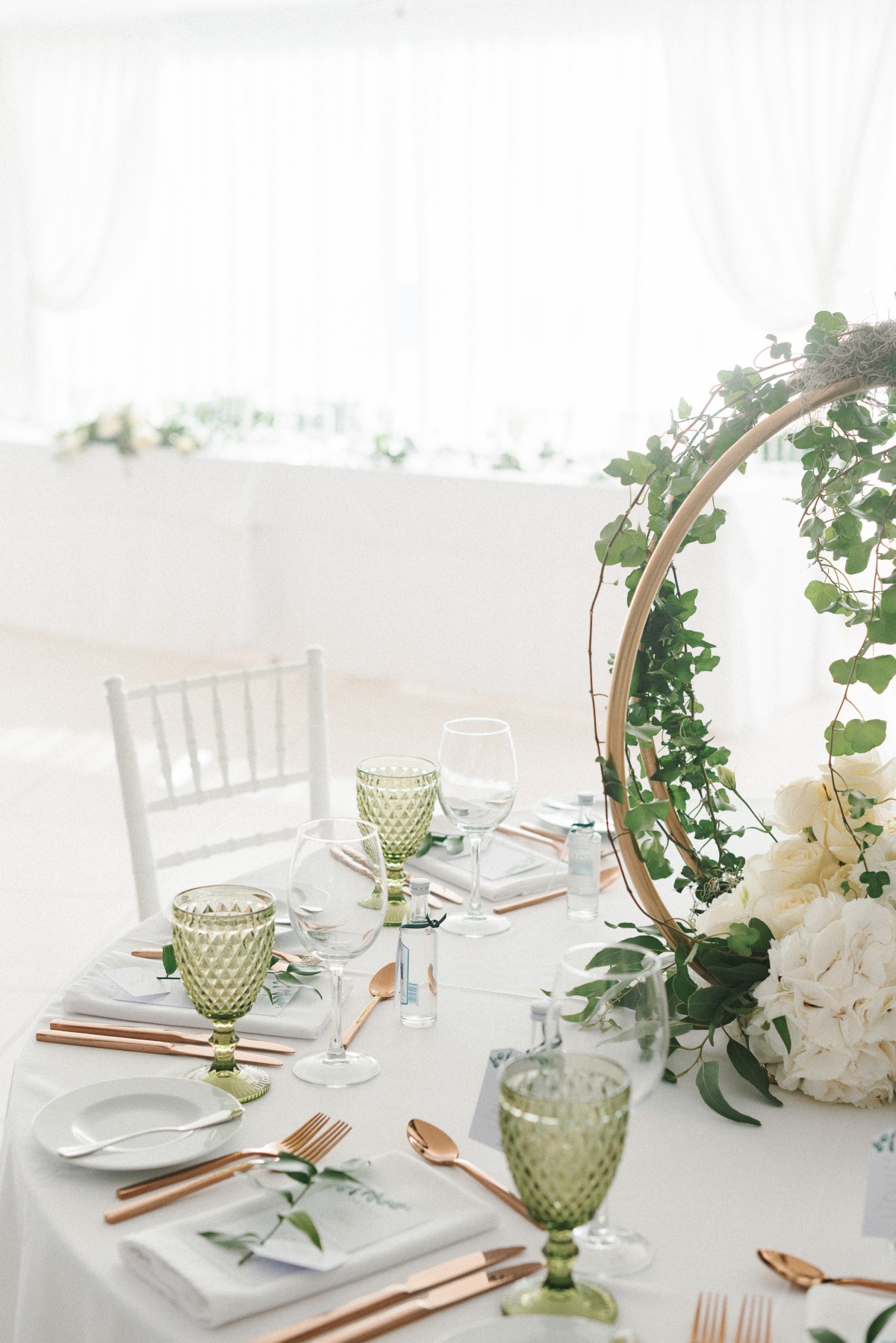 all white wedding reception with circle ivy wedding centerpiece