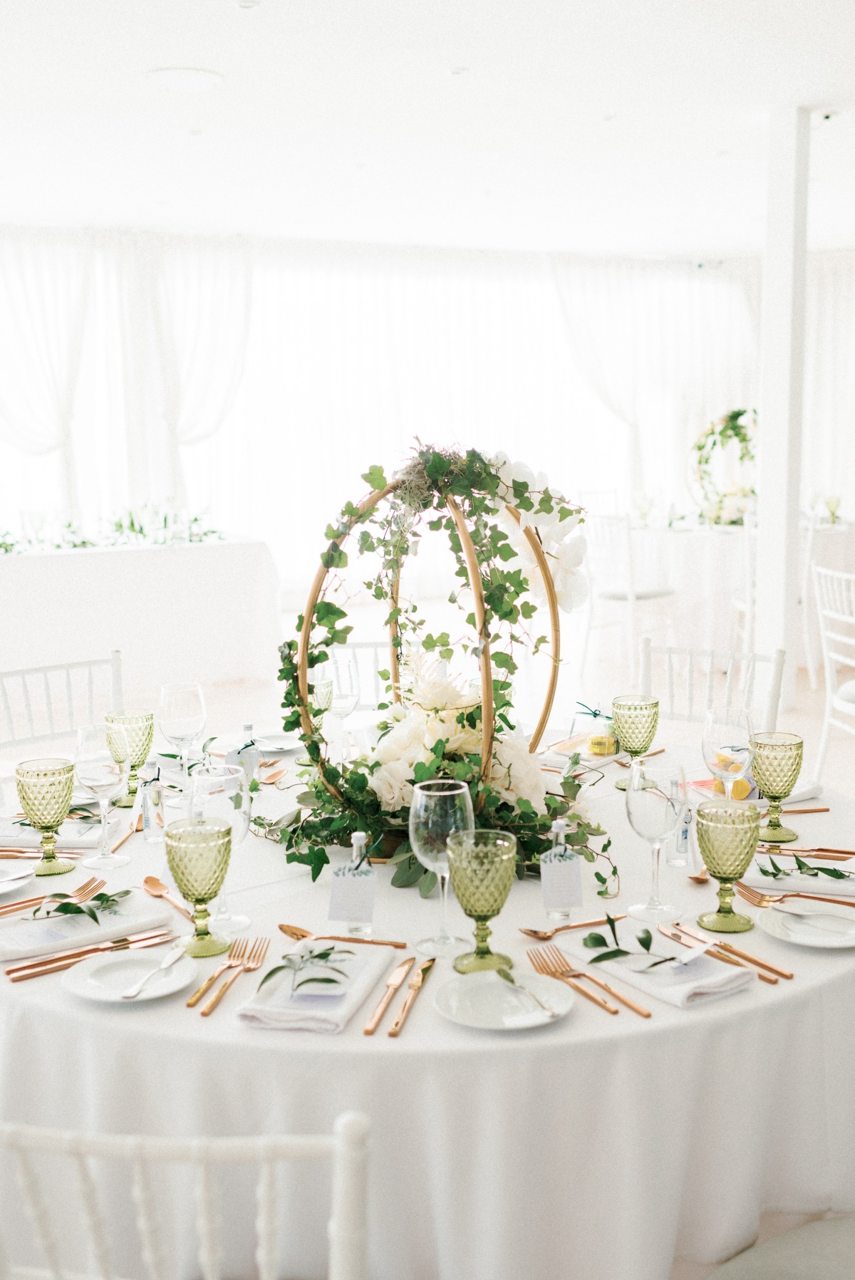 all white wedding reception with circle ivy wedding centerpiece