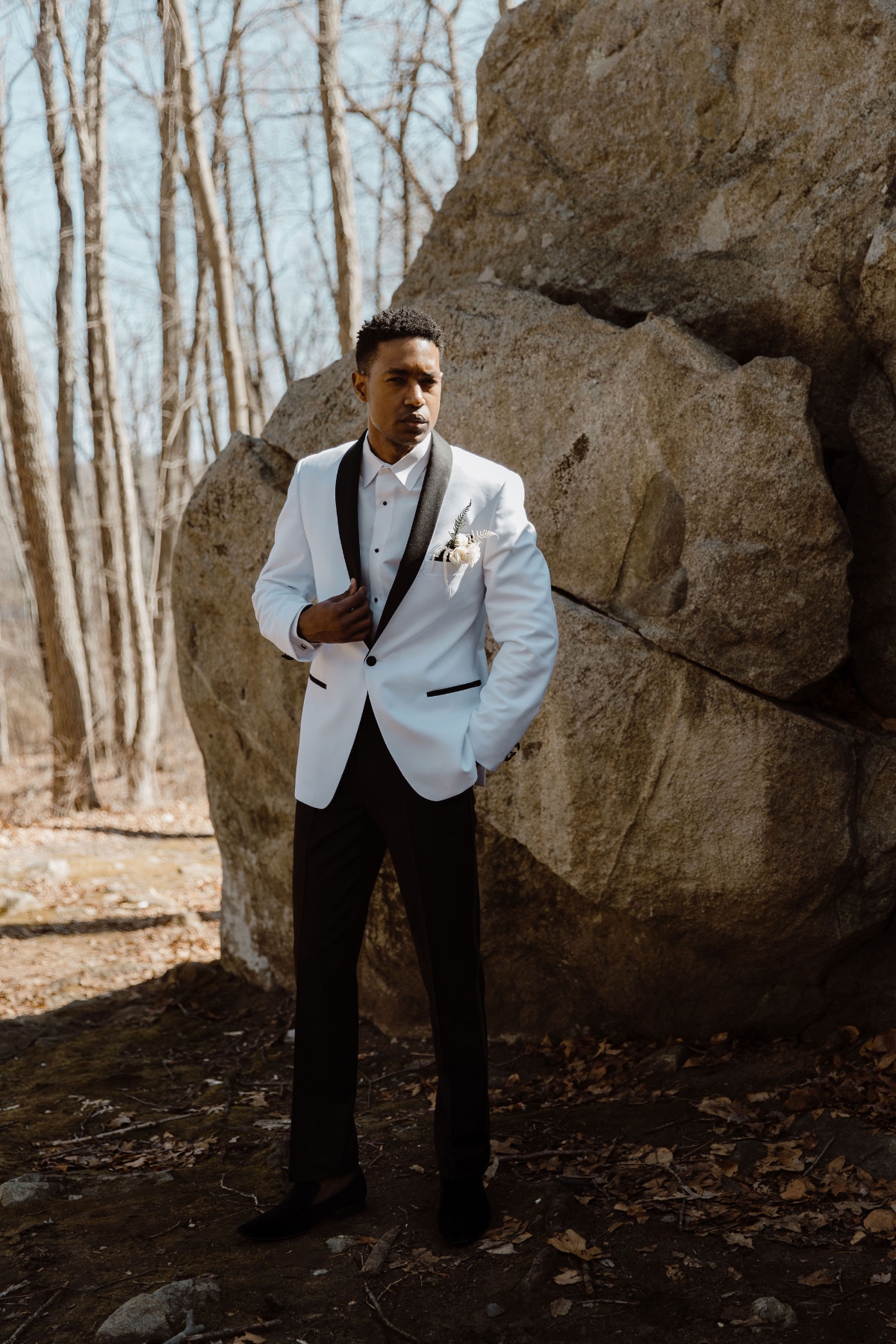 groom in white suite with black trim and rose boutonniÃ¨re from Aldo's House Of Formals