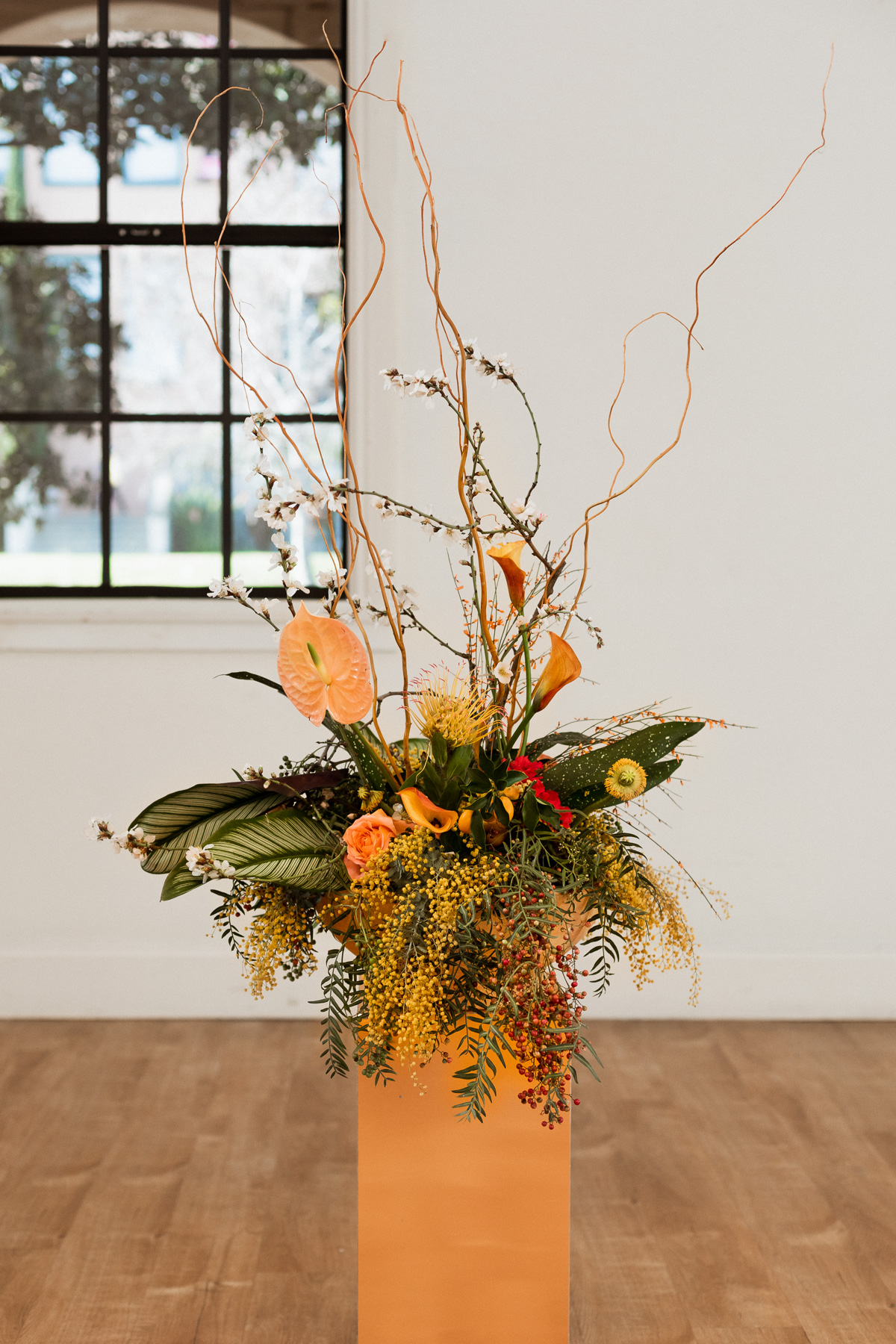 yellow tropical wedding floral arrangement used as aisle decor by New Creations Flower Company