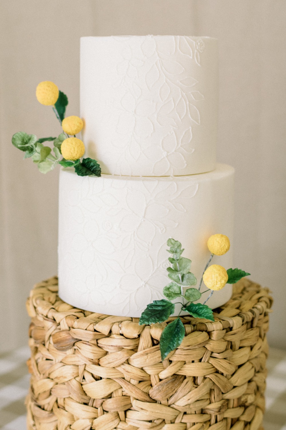 white wedding cake adorned with billy balls from Sweet Autumn Bakery