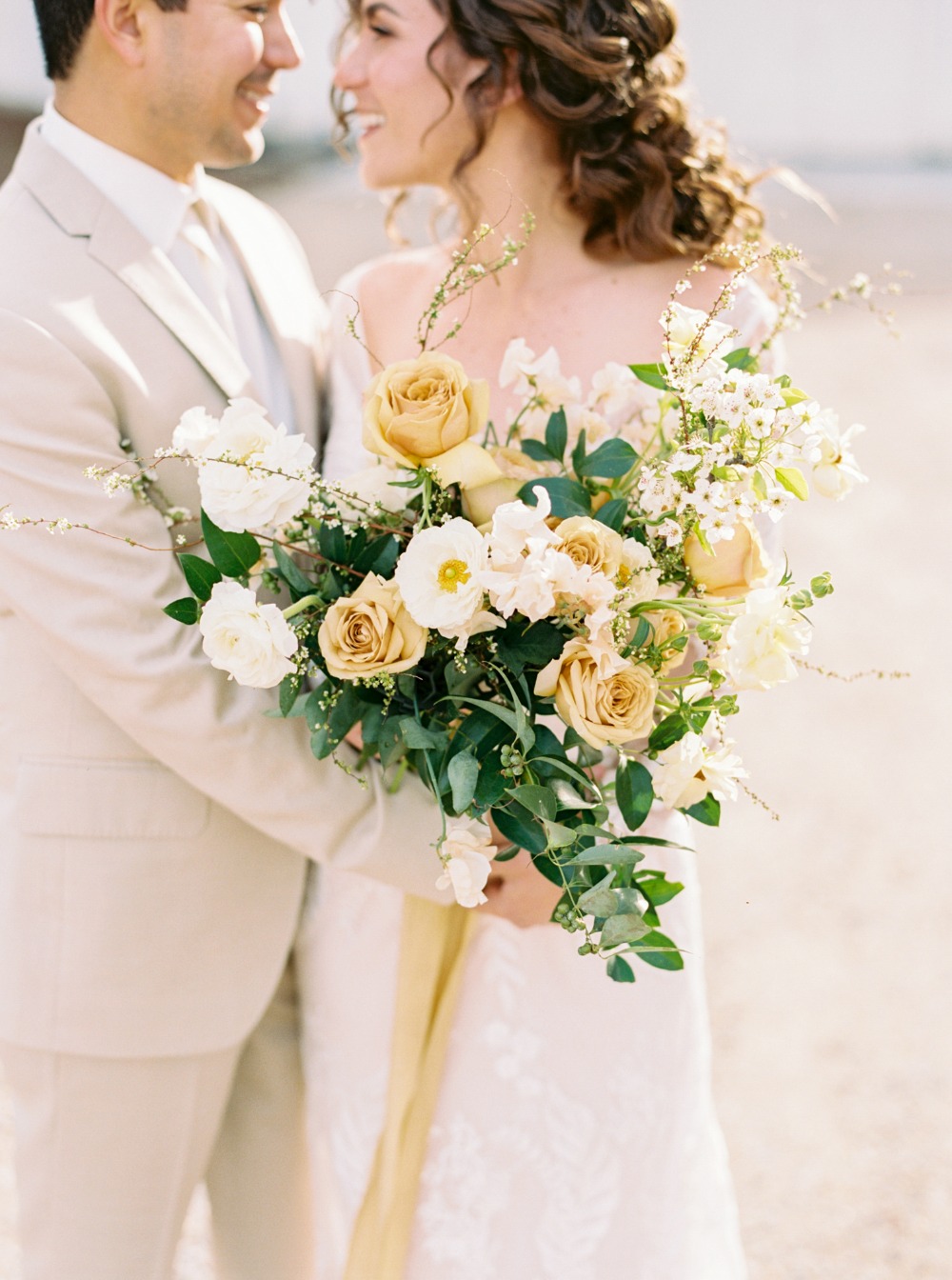 yellow and white wedding bouquet with greenery