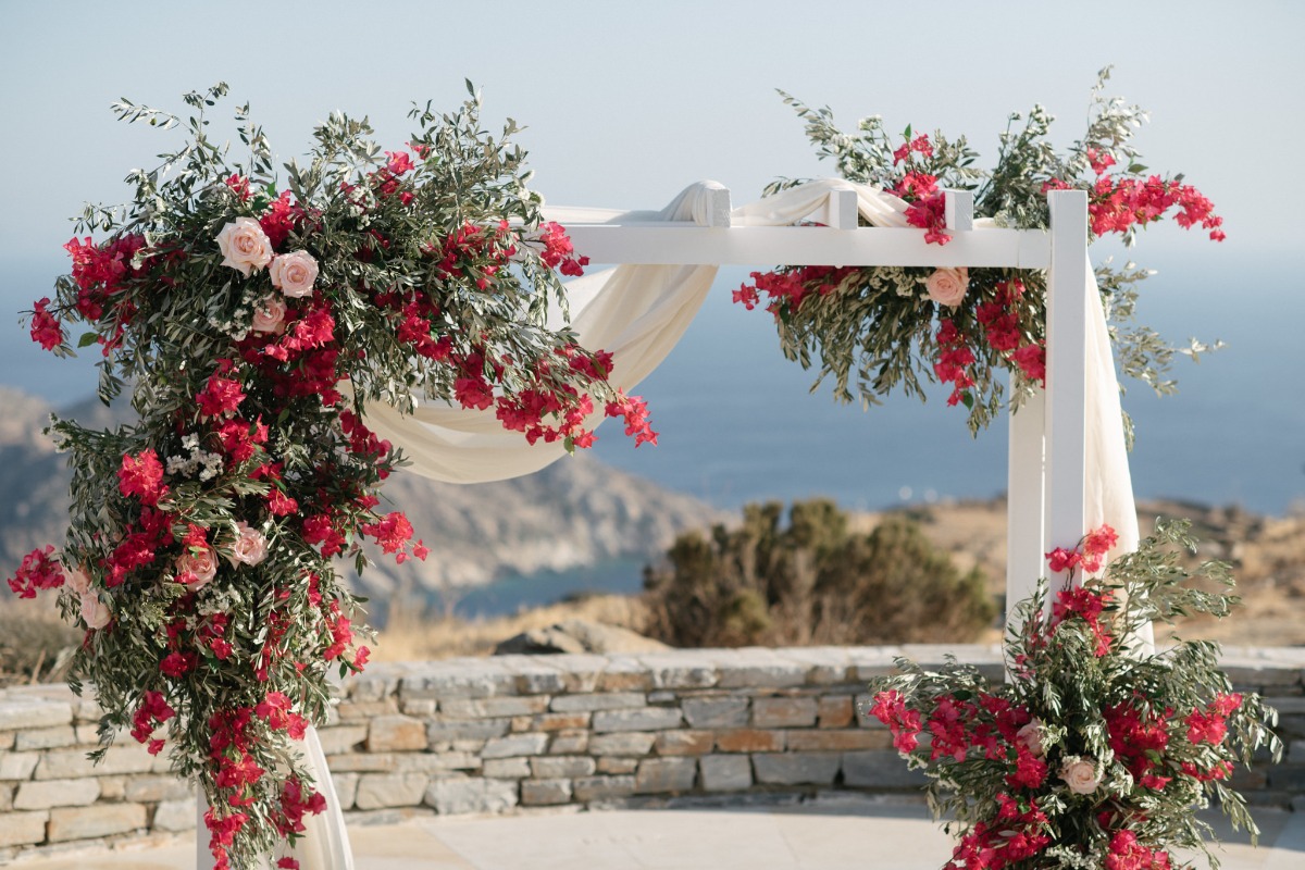 wedding back overflowing with bright pink bougainvillea blooms and garden roses