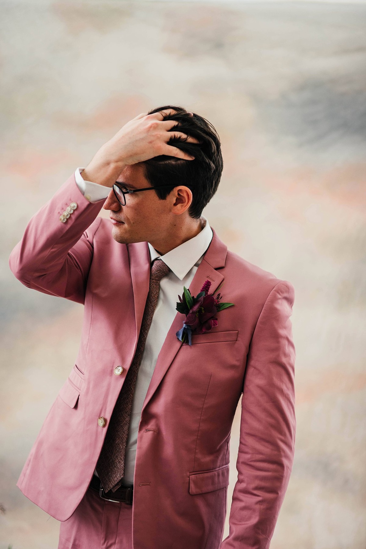 groom in blush suit
