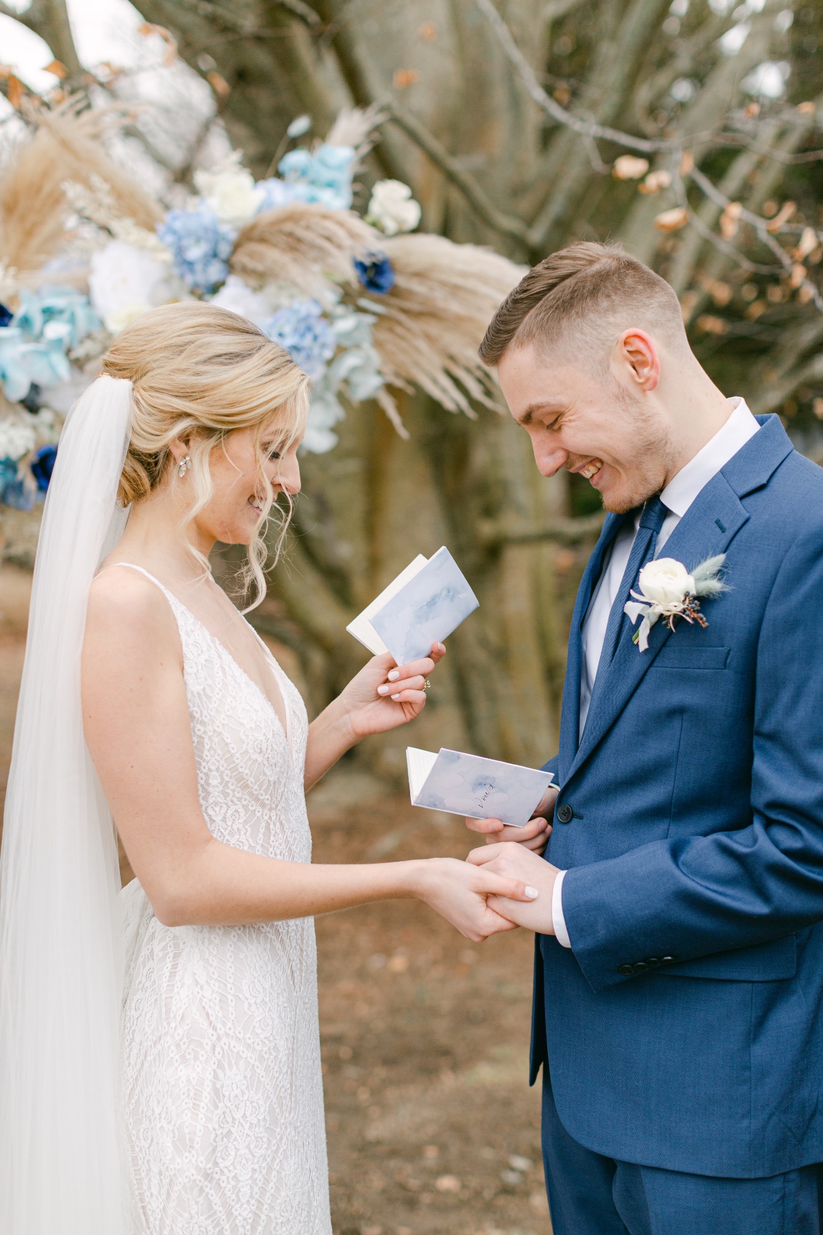 couple holding blue wedding vow books
