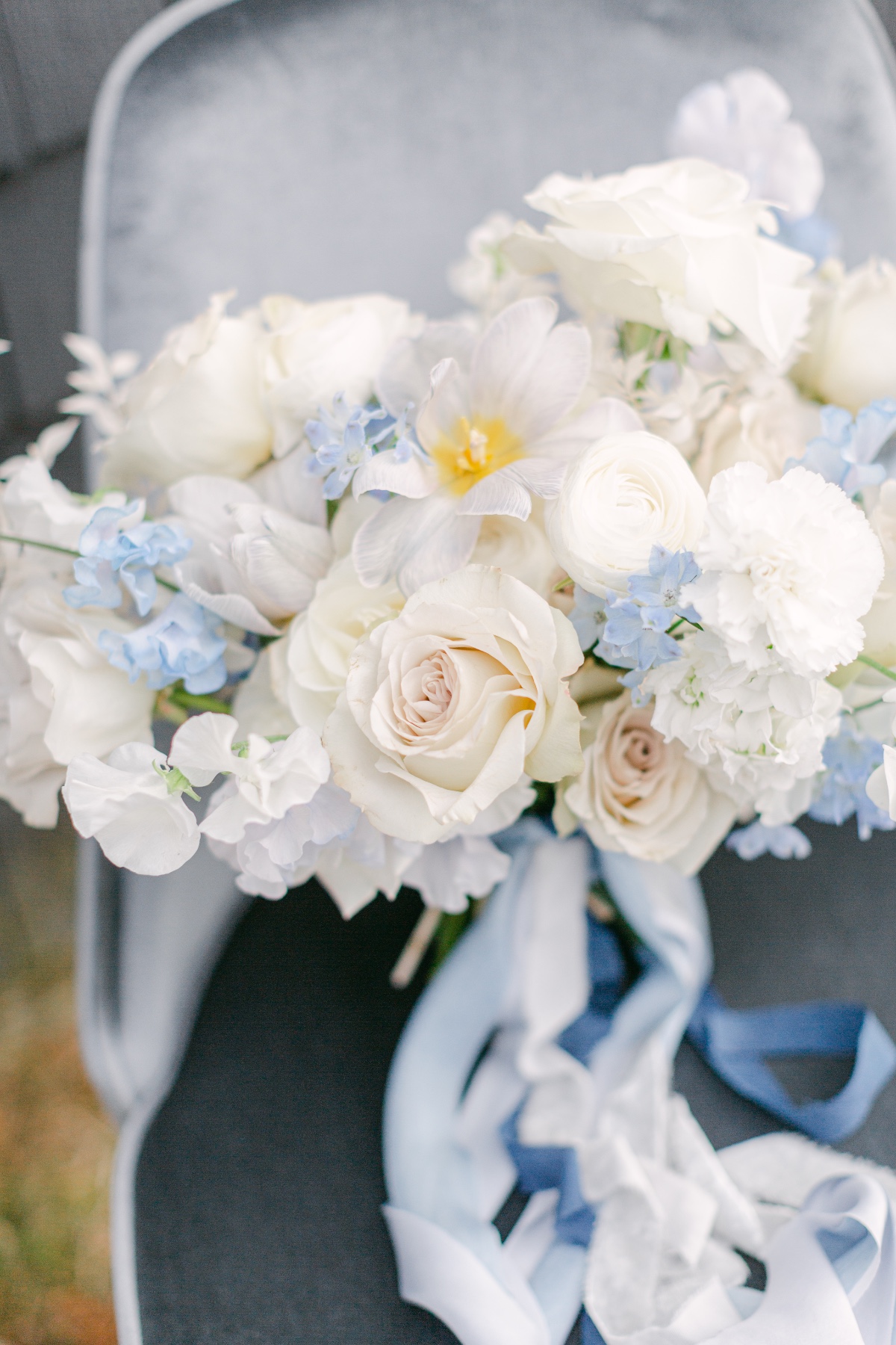 white wedding bouquet paired with silk blue ribbon