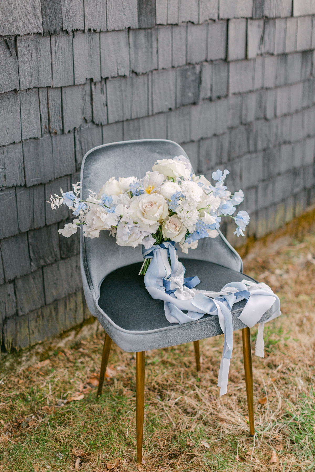 blue and white wedding bouquet on blue velvet chair