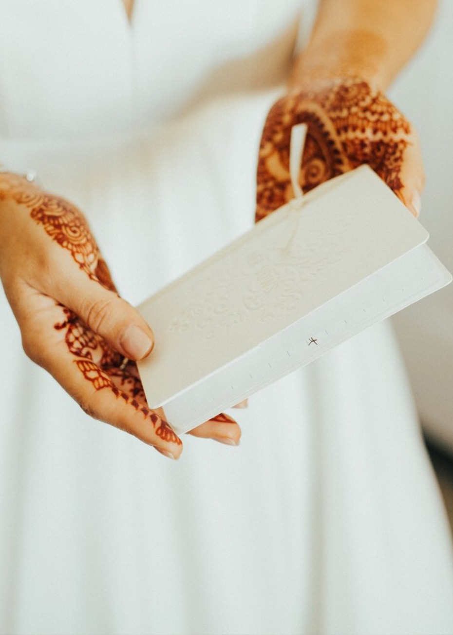 bride holding wedding vow book