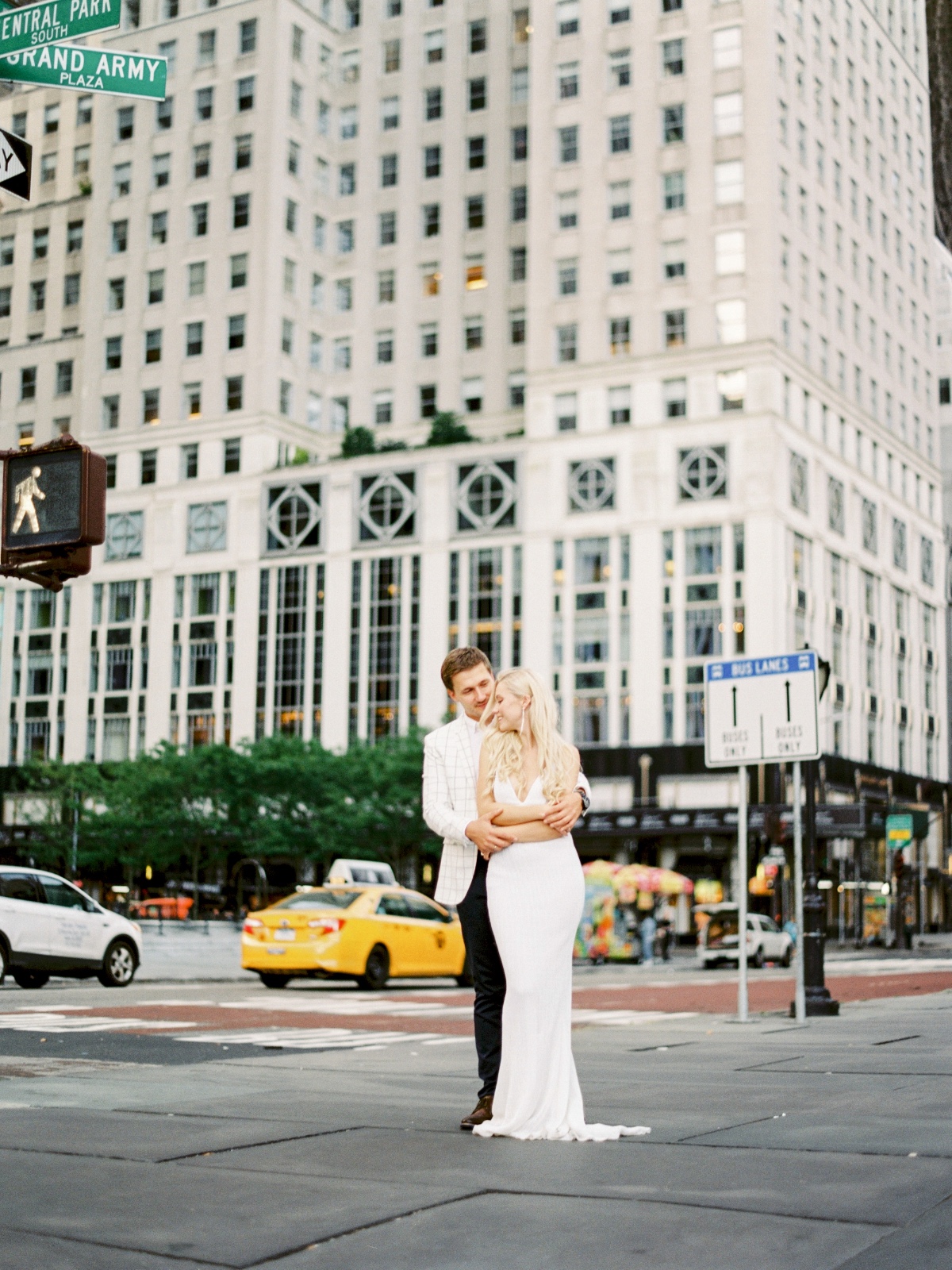 Couple embraces in NYC street, wedding or engagement photoshoot