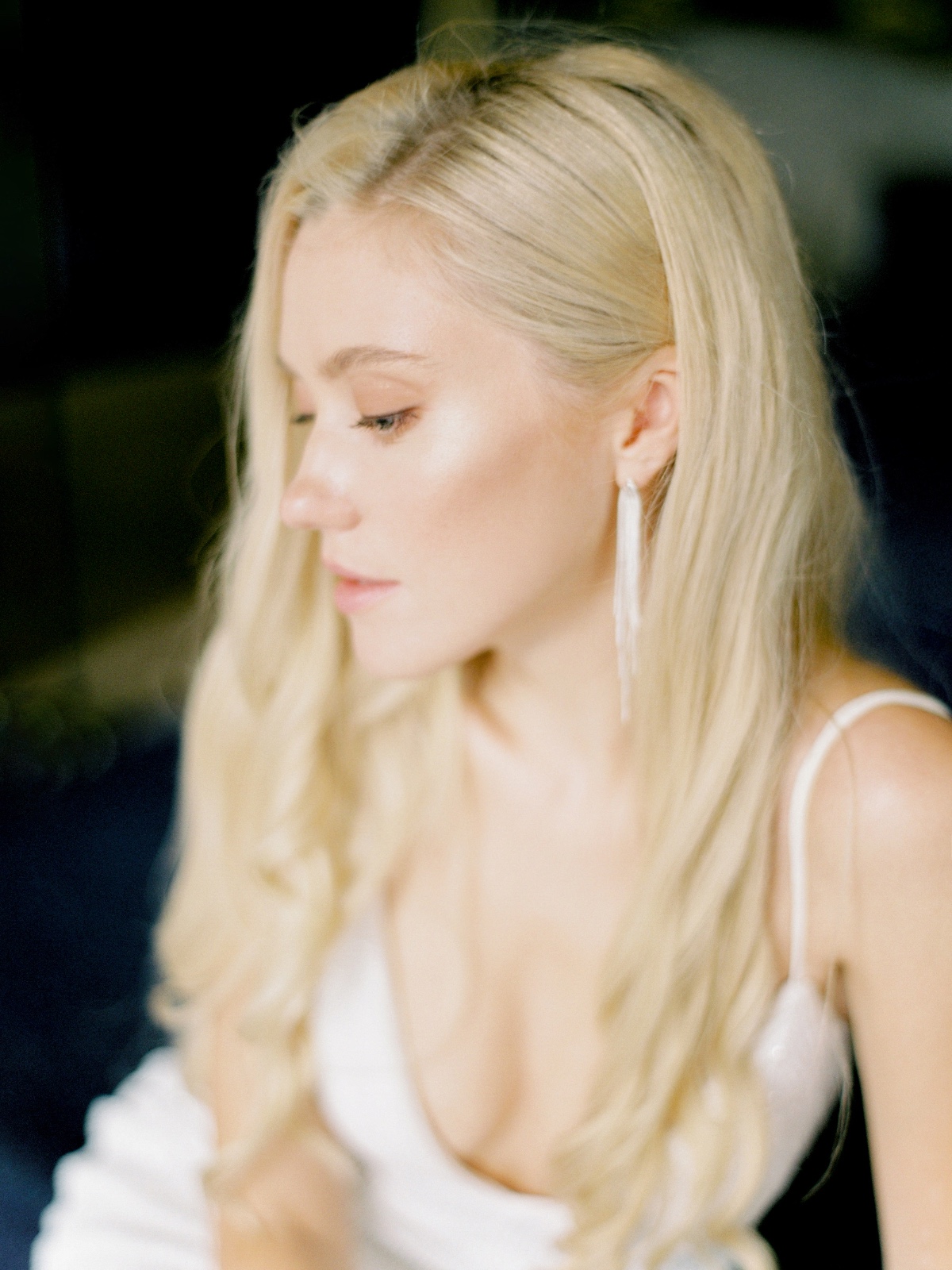 Beautiful blonde woman with long hair in a white dress