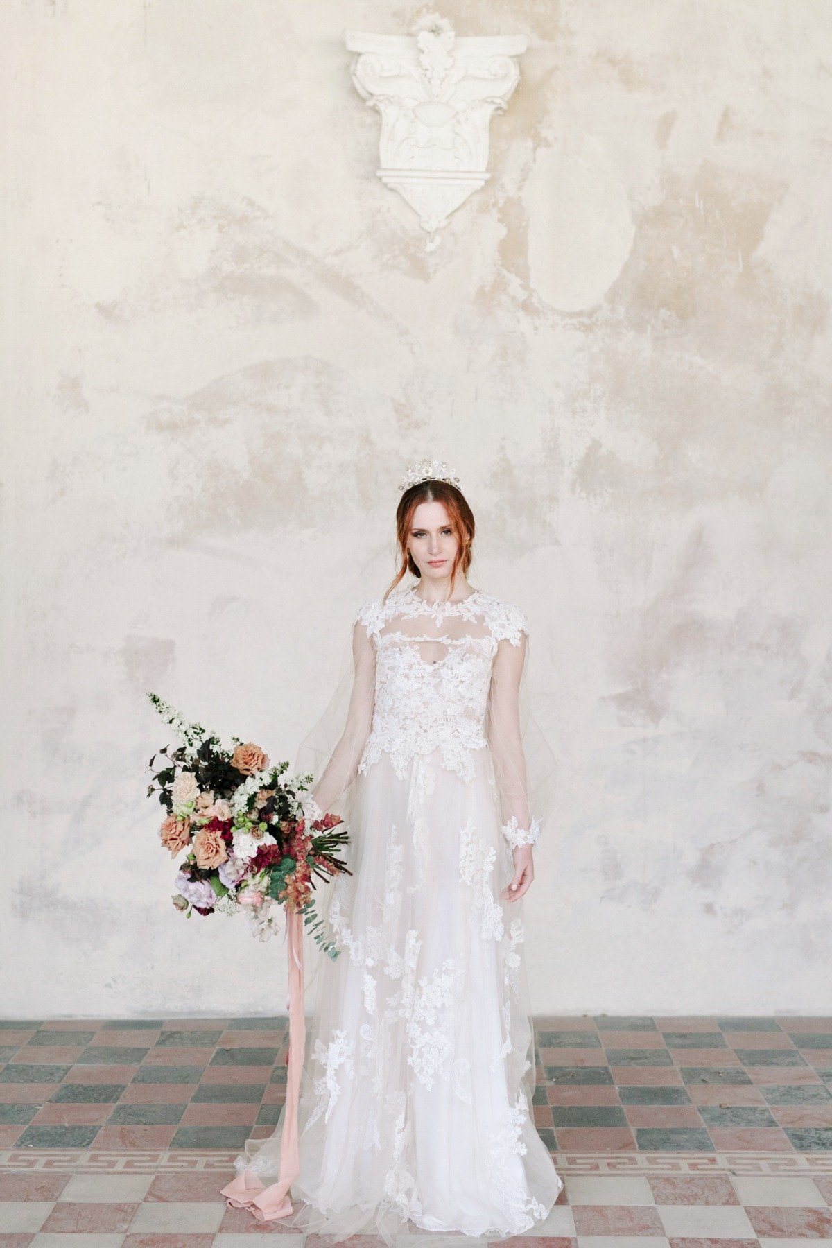 long sleeve wedding dress with full bouquet