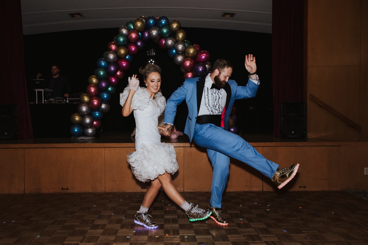 bride and groom in light up sneakers at their costume inspired wedding