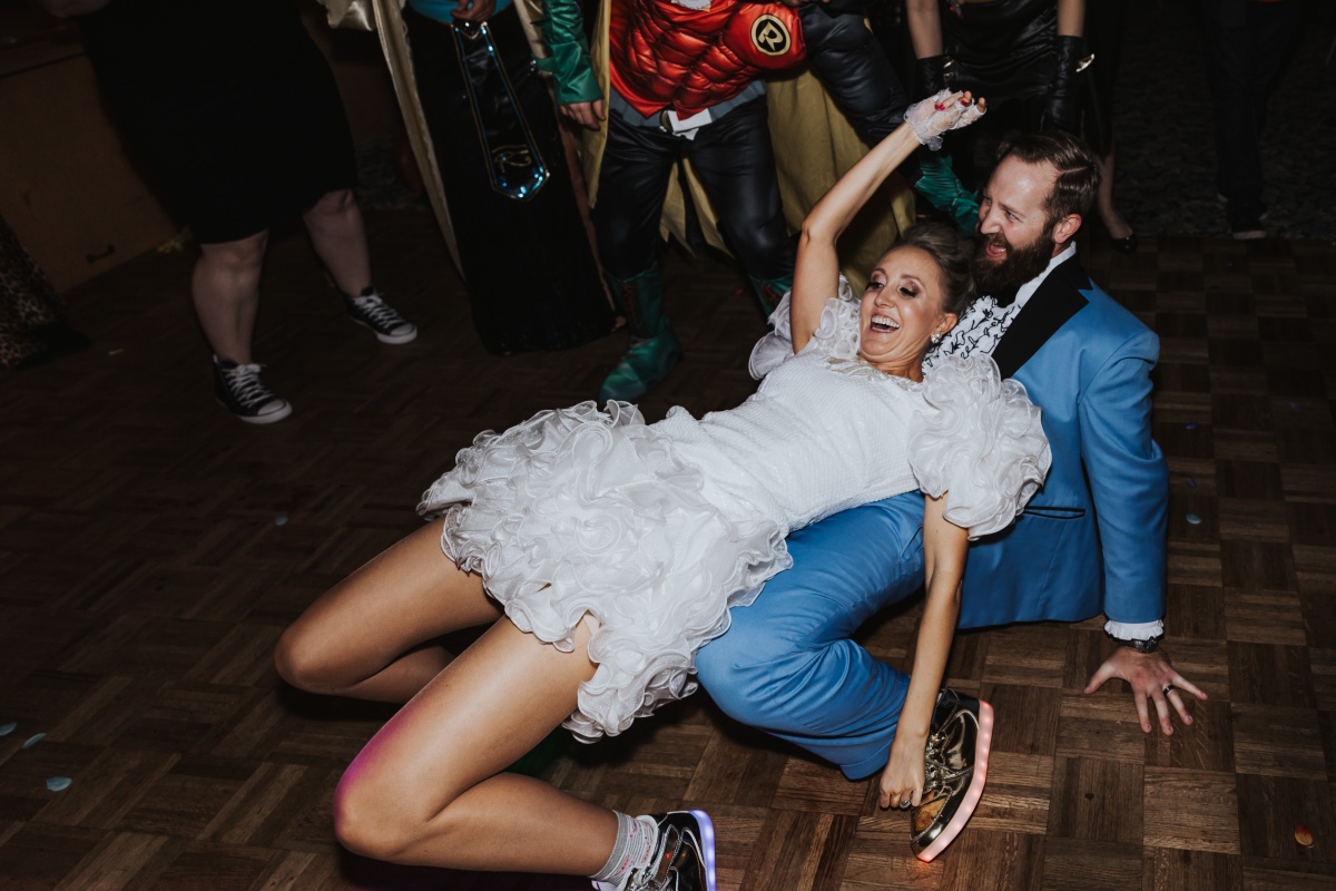 bride and groom in light up sneakers at their costume inspired wedding