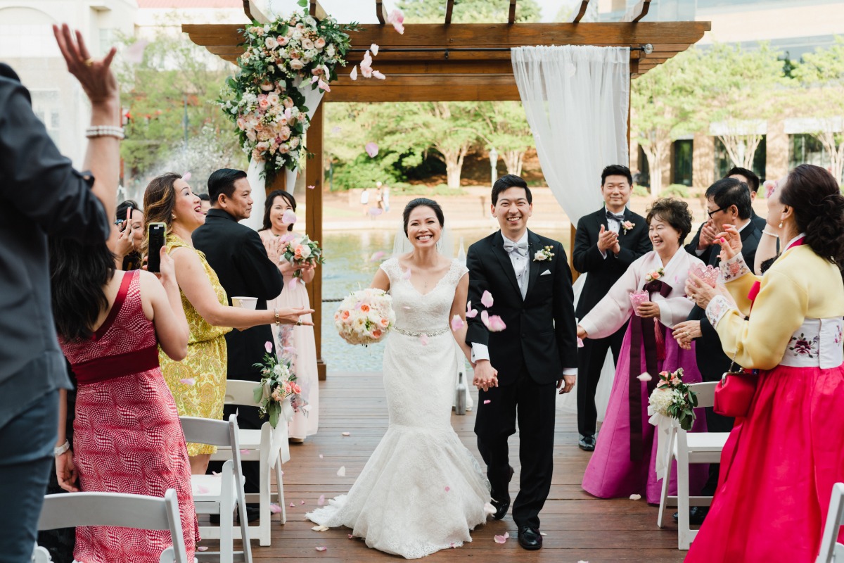 Happy Asian couple wedding celebration with flower petals