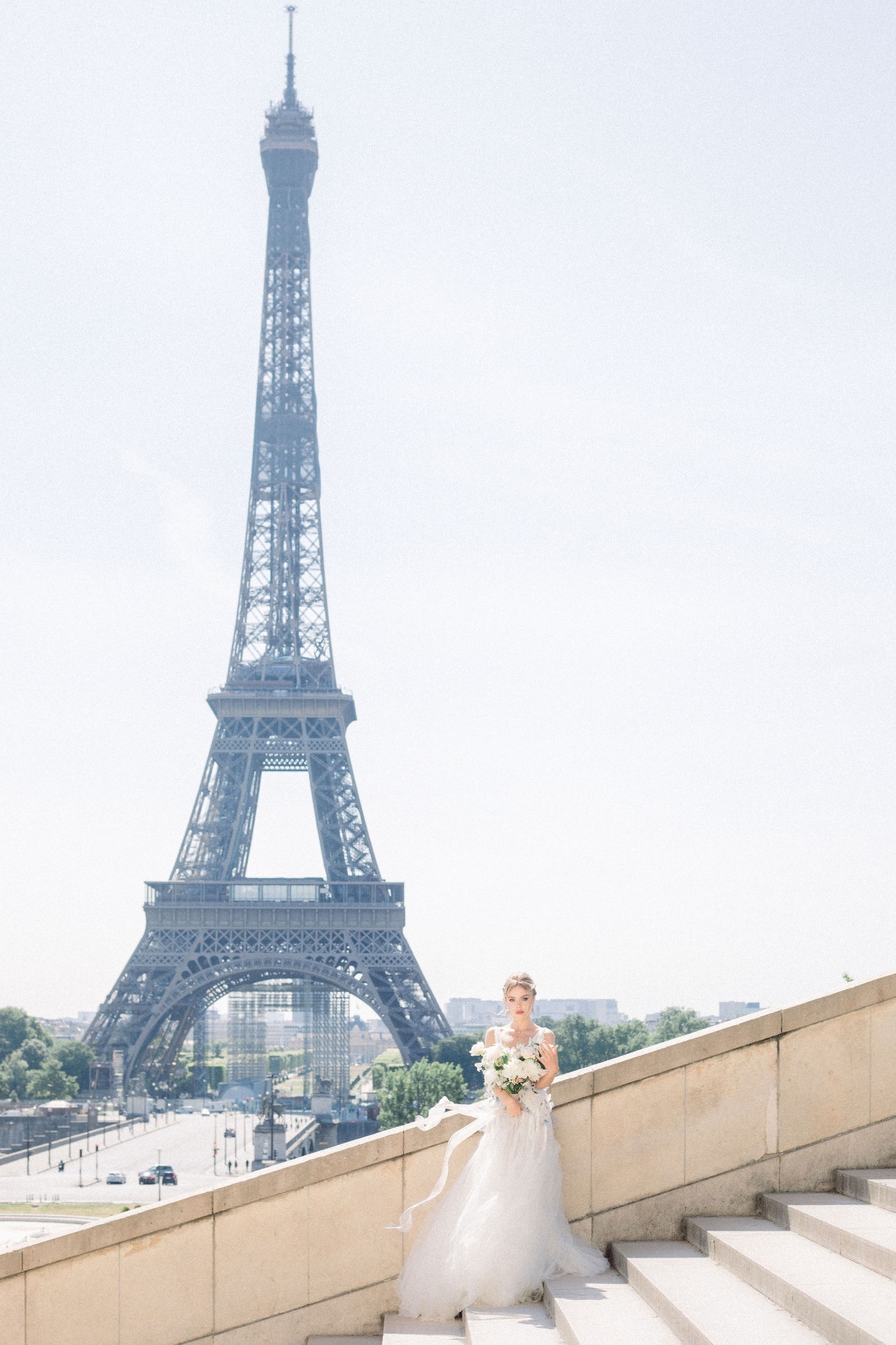 bridal photoshoot by the Eiffel tower in a Myoo Couture wedding gown