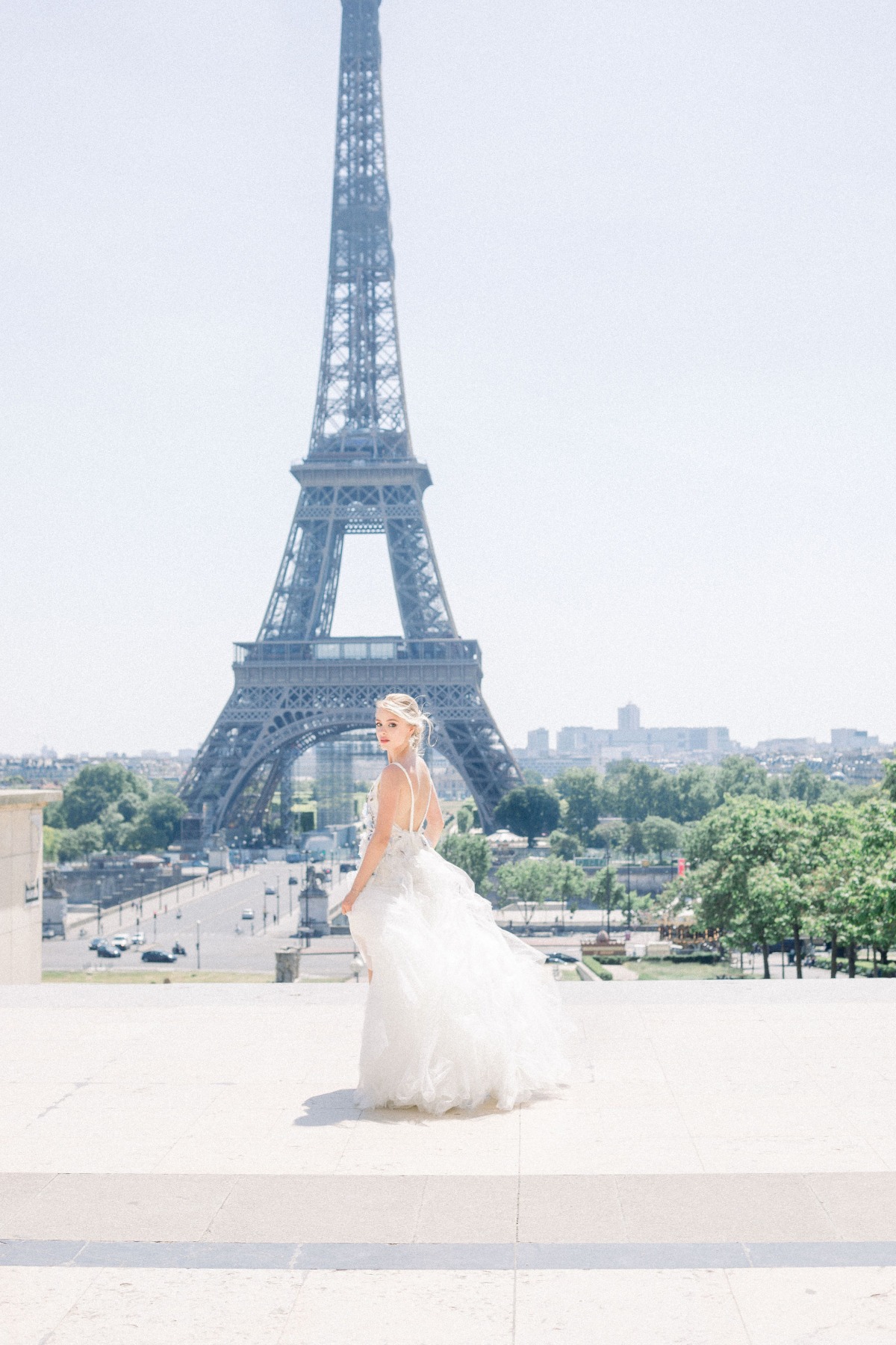 bridal photoshoot by the Eiffel tower in a Myoo Couture wedding gown