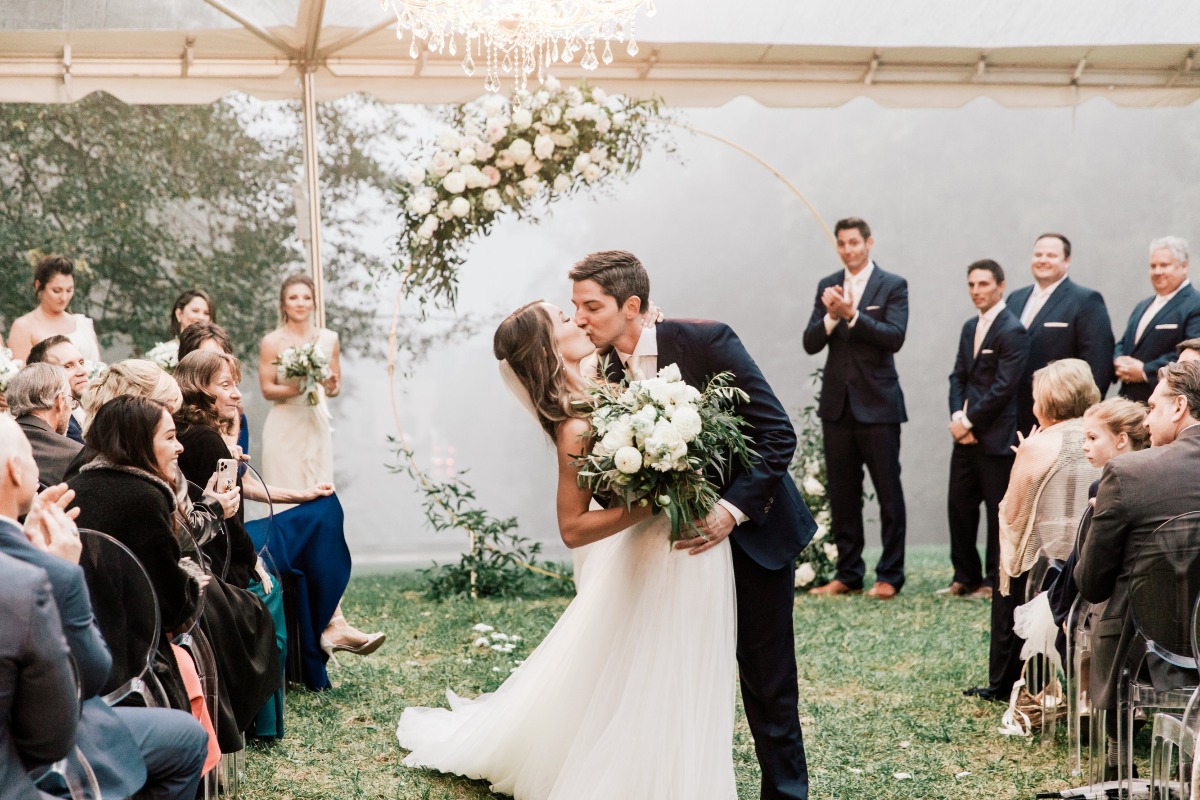 outdoor wedding in the rain under a tent