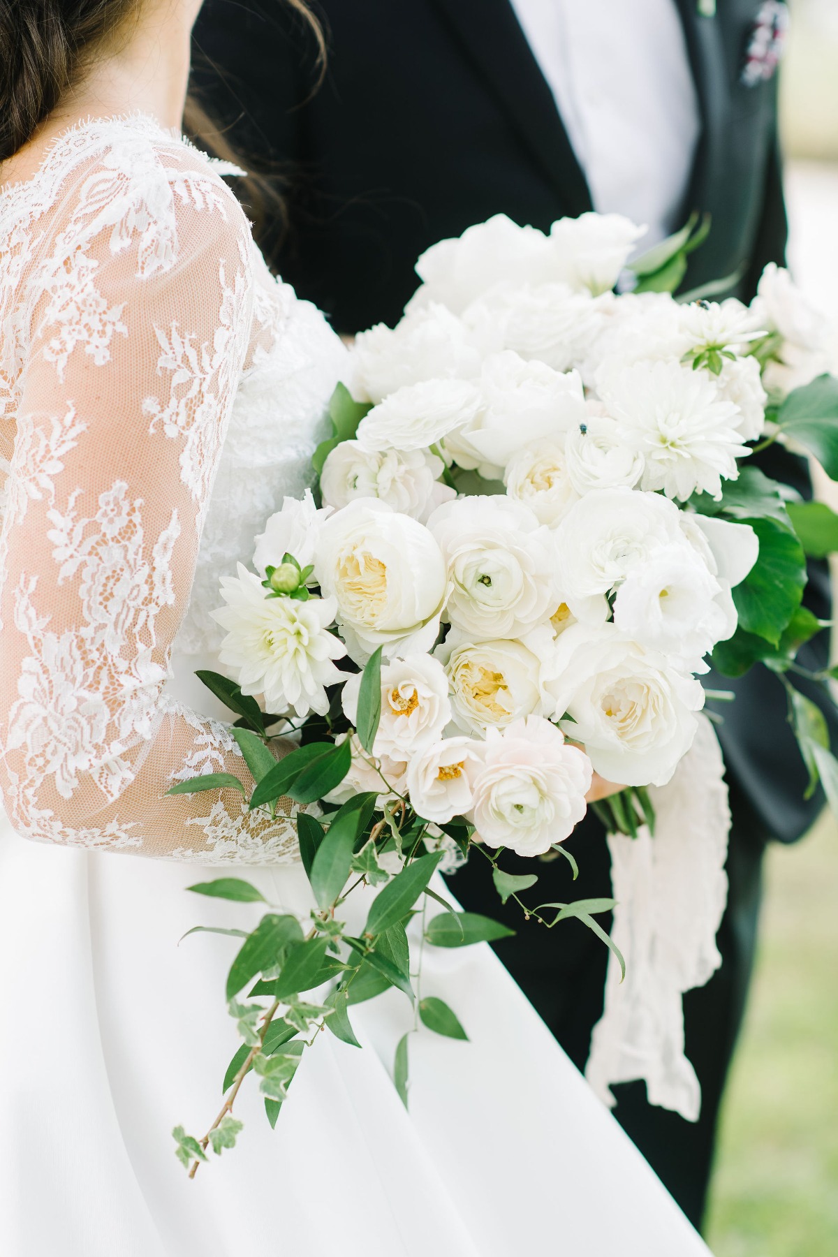 all white wedding bouquet with a sprinkle of greenery