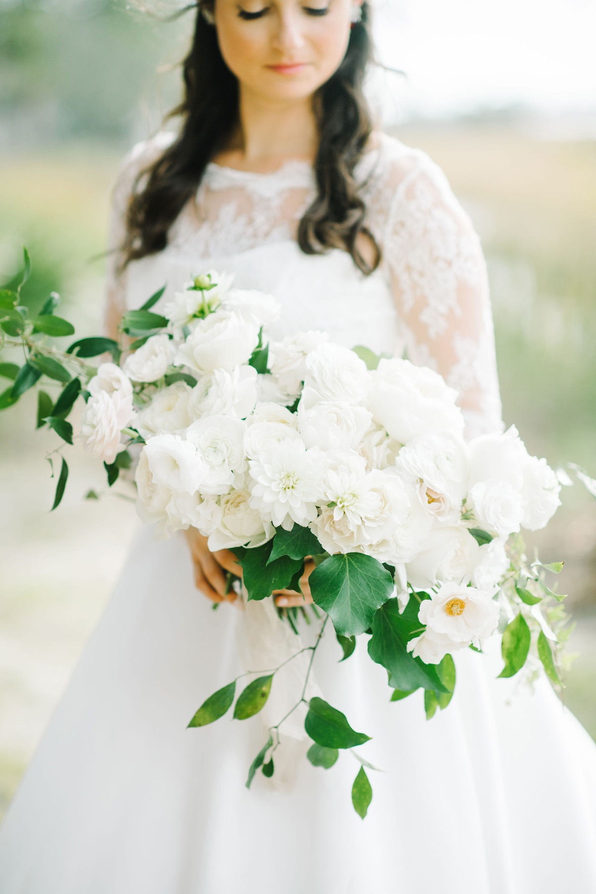 all white wedding bouquet with a small amount of greenery designed by Petaloso