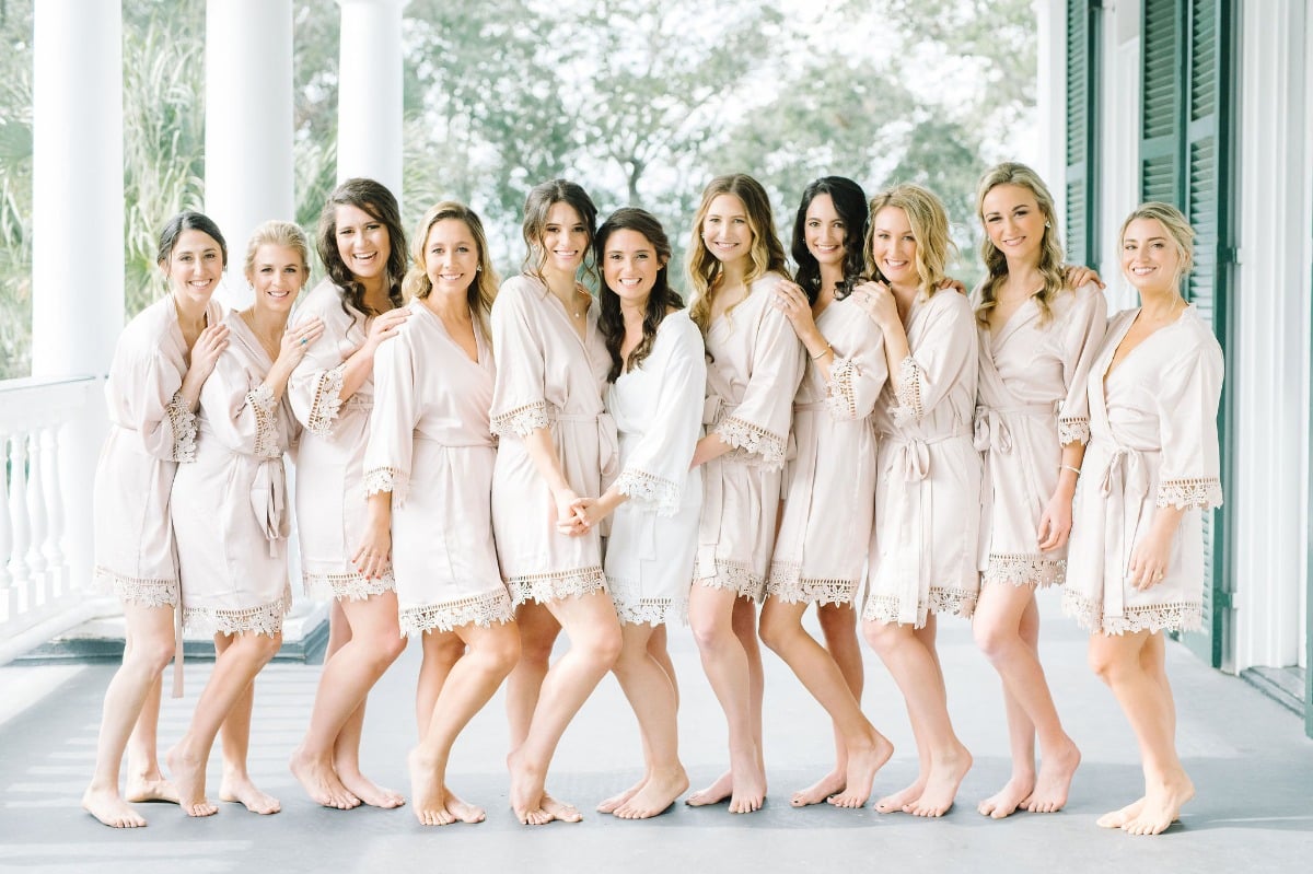 bridesmaids in blush wedding robes with lace edges