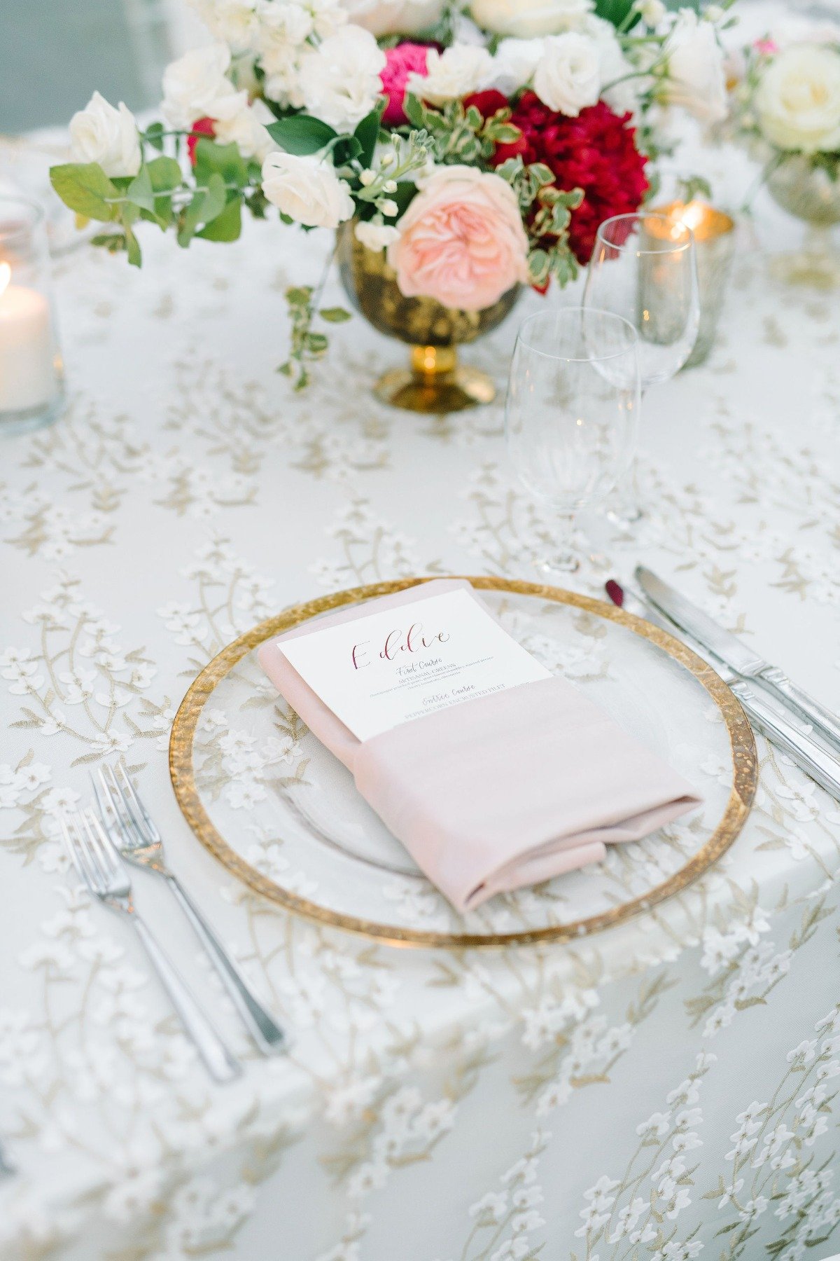 clear gold rimmed chargers with blush napkins for table setting