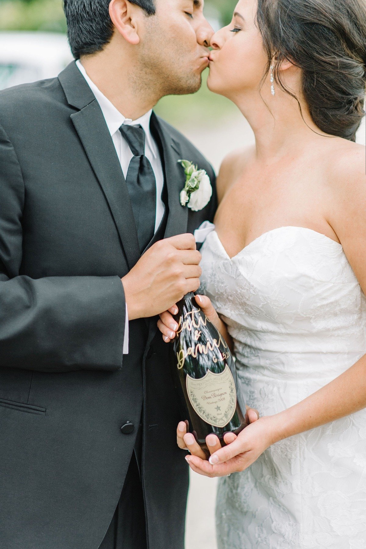 bride and groom with bottle of Champange