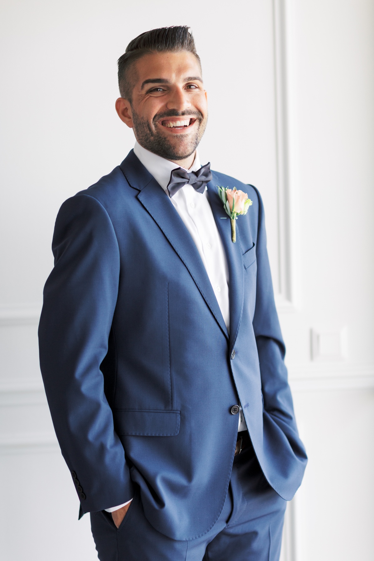 navy suit with black bow tie