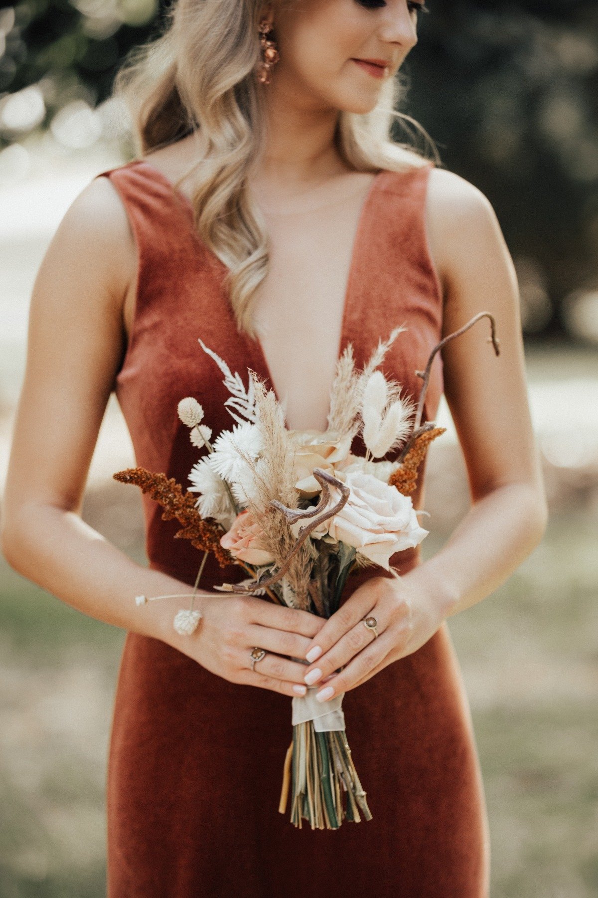 terra cotta bridesmaid dress with dried floral wedding bouquet